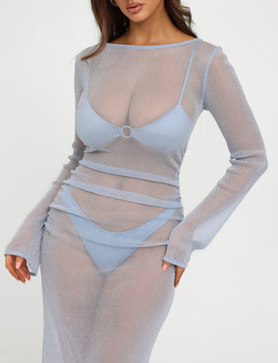 A person is wearing the TIGERMIST ALAYNA THREE PIECE MAXI DRESS in pale blue, paired with matching light blue lingerie. The dress features a form-fitting silhouette and is semi-transparent, revealing the undergarments beneath against a plain white background.