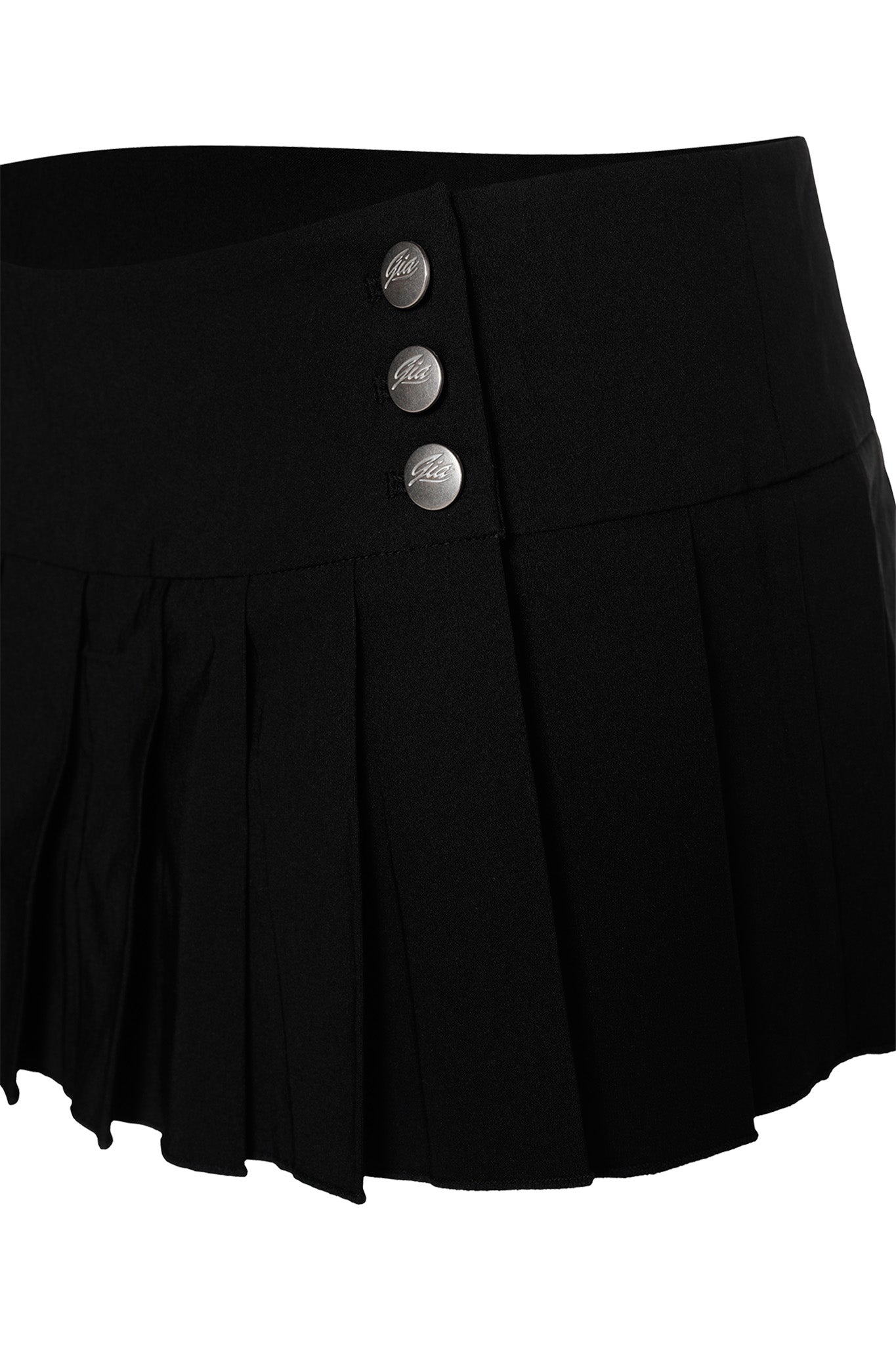 The REMINI SKORT - BLACK by I.AM.GIA is a black pleated micro mini skort with three metallic buttons and a wide waistband, shown against a white background.