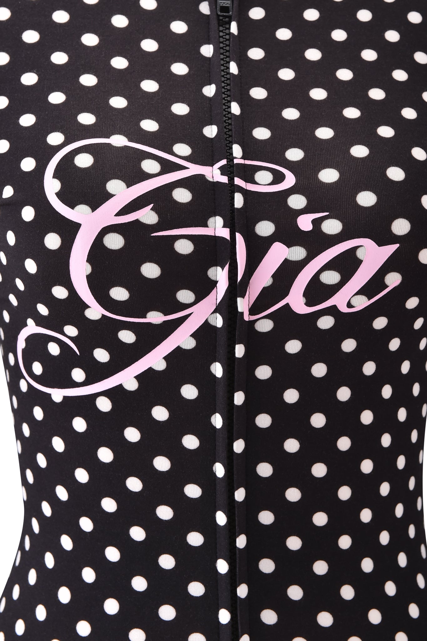 Close-up of the BLARE HOODIE - BLACK POLKA DOT by I.AM.GIA, featuring white polka dots, a vertical center zipper, and a large pink cursive I.AM.GIA logo across the front.