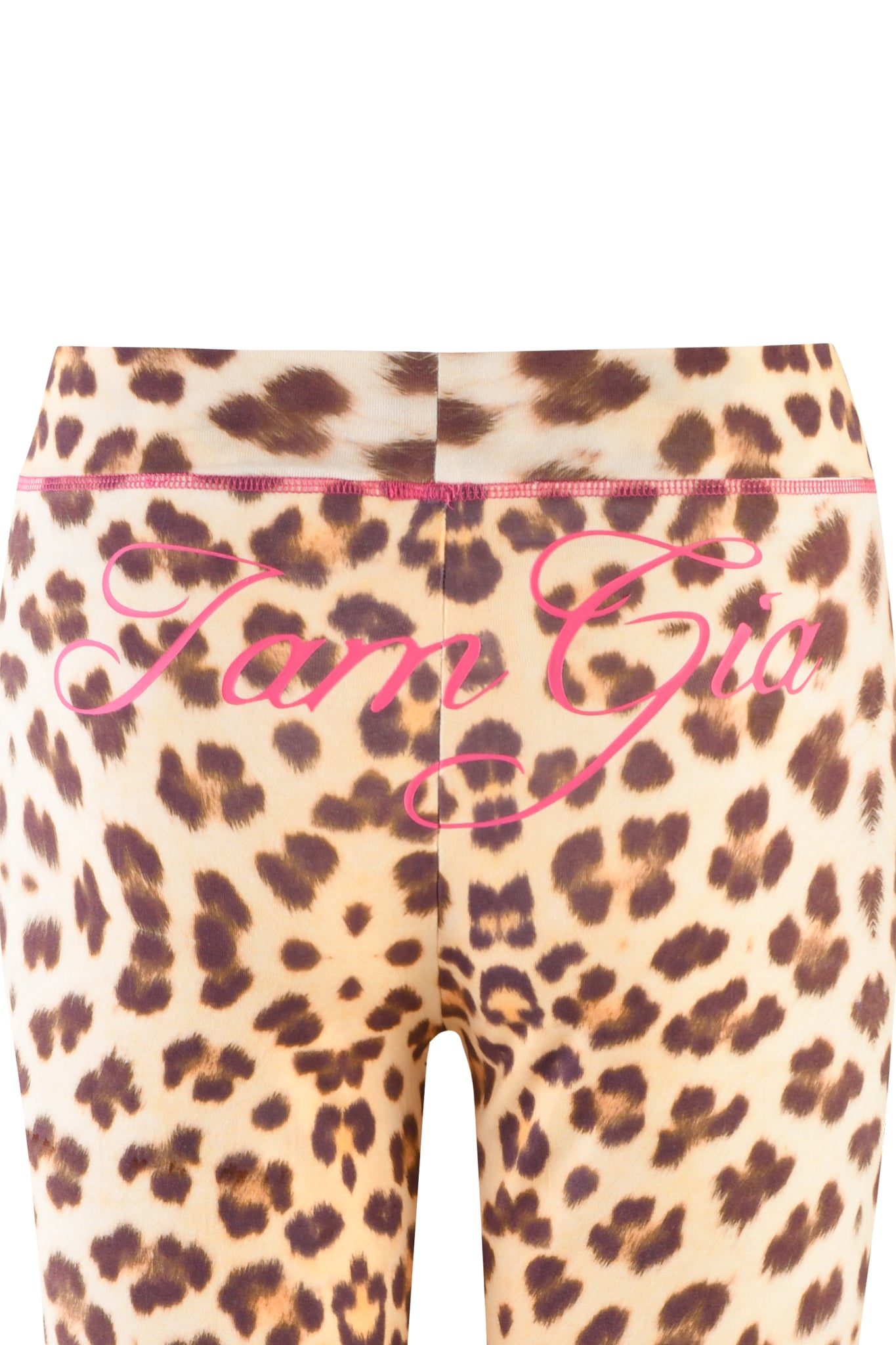 Close-up of the back of I.AM.GIA BLARE TRACKPANT - NEUTRAL: LEOPARD: WILD CARD, showcasing leopard print leggings with "I am Gia" in bold pink script across the waistband and upper leggings.