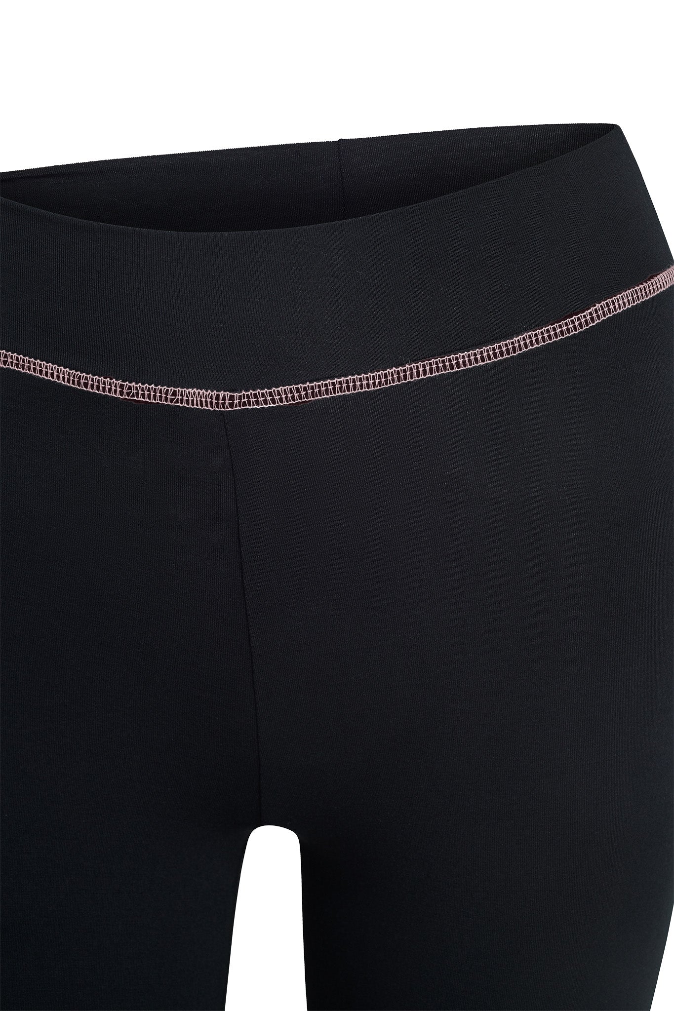 Close-up of the waistband and upper legs of the BLARE TRACKPANT - BLACK by I.AM.GIA, featuring a visible pink stitched seam across the front.
