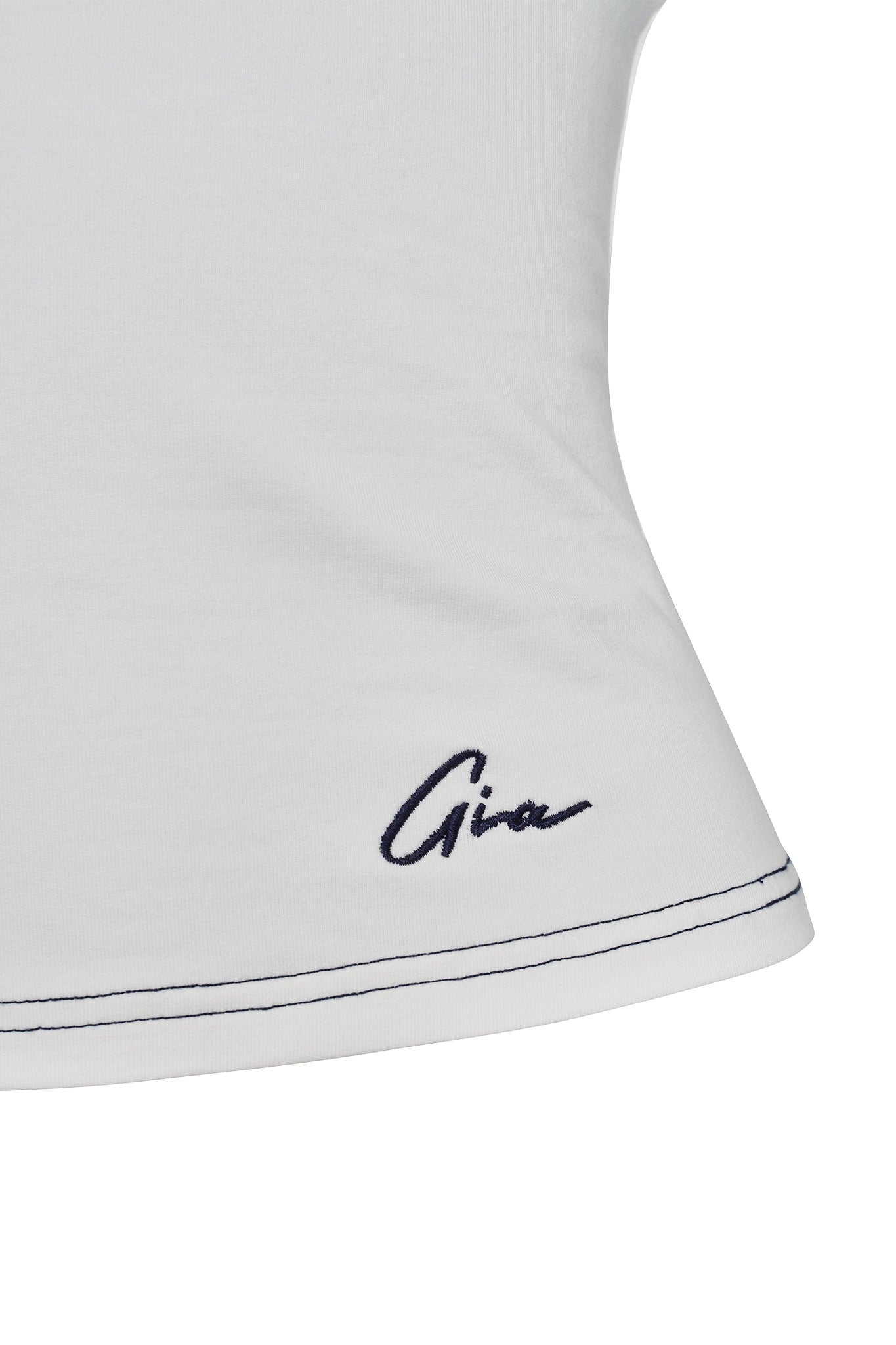 Close-up of the EDITA TOP in white by I.AM.GIA, featuring navy blue stitching along the hem and "Gina" embroidered in cursive near the edge, inspired by the brand's classic tank top style.