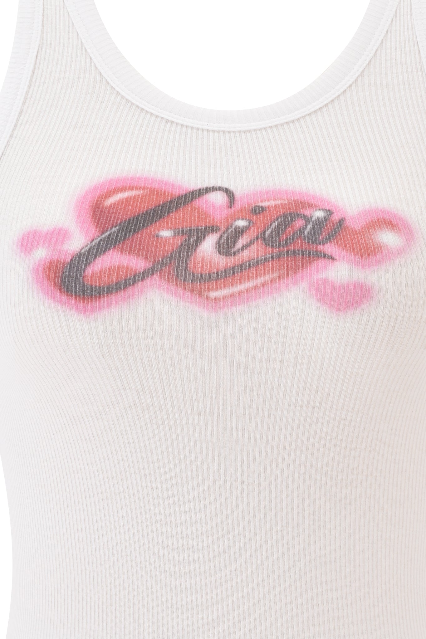 A close-up of the I.AM.GIA PENELOPE TANK - PINK AIRBRUSH, a white ribbed racer tank featuring "Gia" in black and pink airbrush-style lettering across the chest.