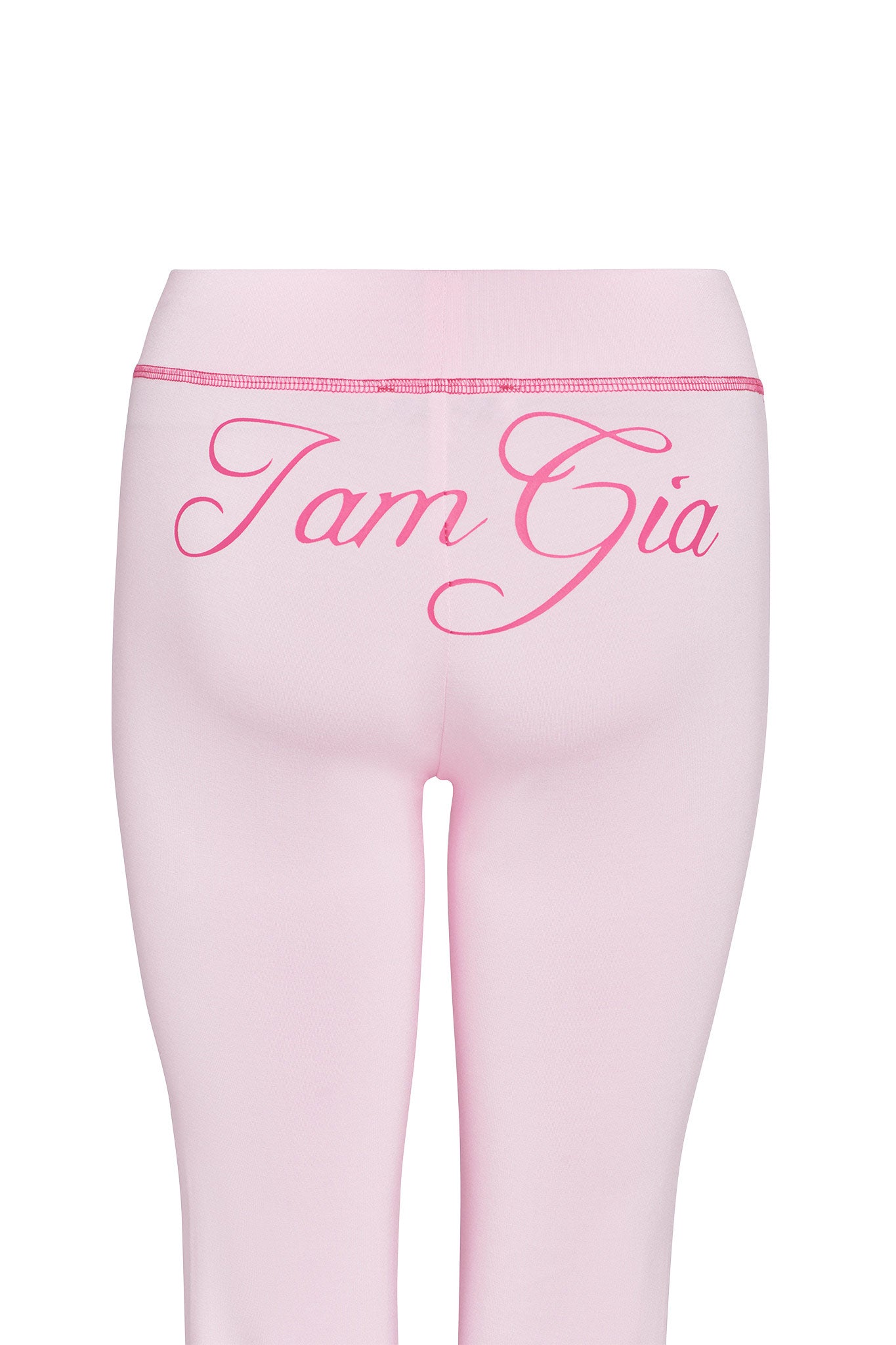 Back view of the BLARE TRACKPANT in pastel pink by I.AM.GIA, featuring large, cursive "Iam Gia" print across the waistband for an iconic look.