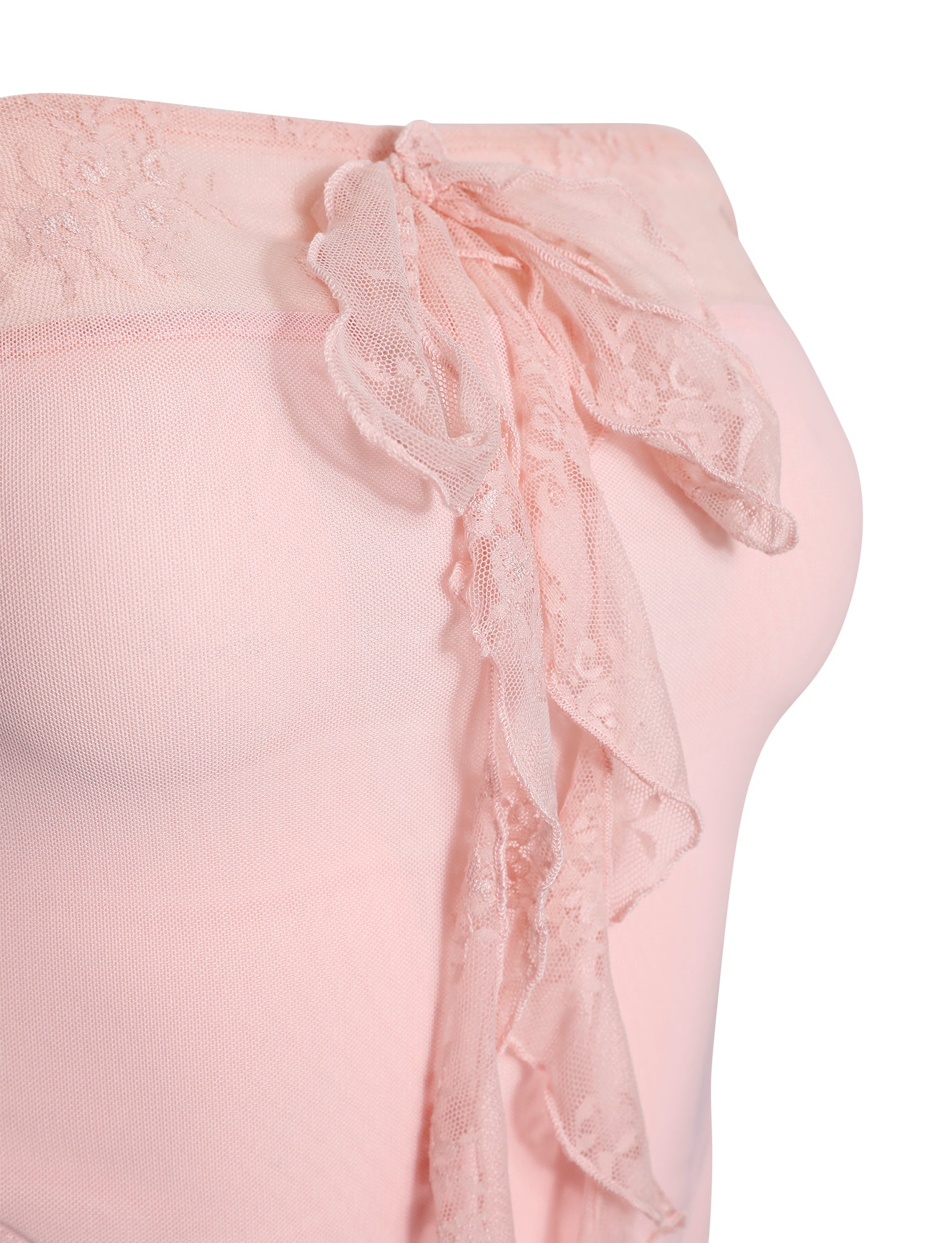 A close-up image of the Harper Top in pastel pink by TigerMist highlights its delicate, sheer fabric adorned with a subtle floral lace pattern. The top features a decorative lace bow and ruffles along the edge, creating a soft, feminine aesthetic.