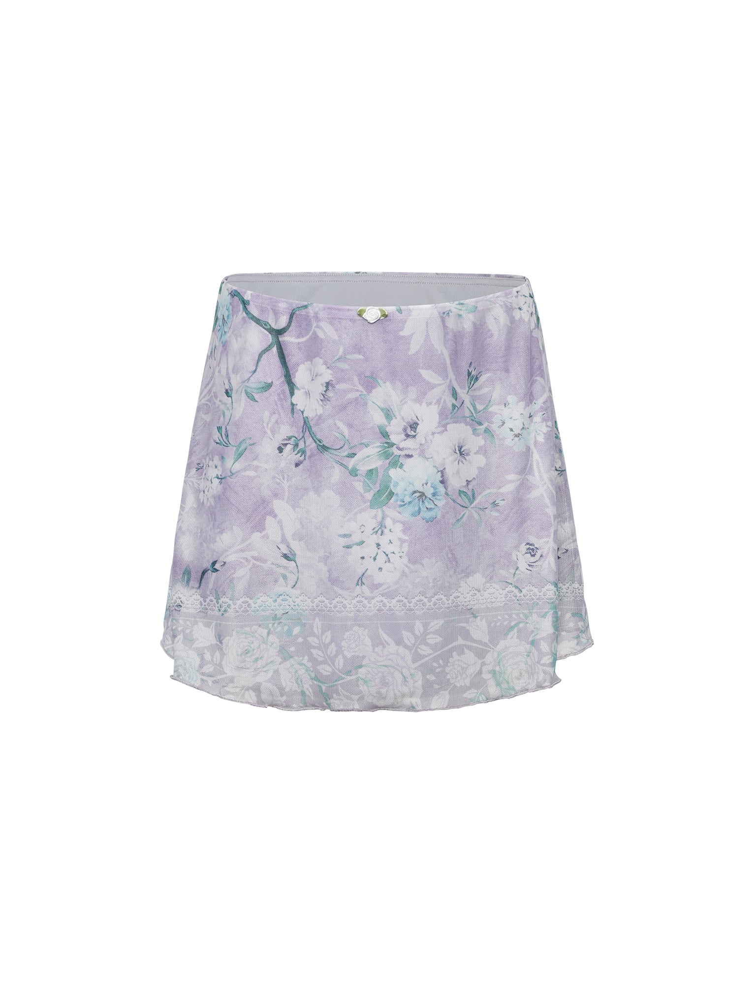 The AMARAN Mini Skirt in Purple from TIGERMIST is a lavender-colored, floral-patterned mini skirt adorned with delicate white lace trim near the hem. It features a soft, flowy fabric with varied shades of purple and white flowers throughout.