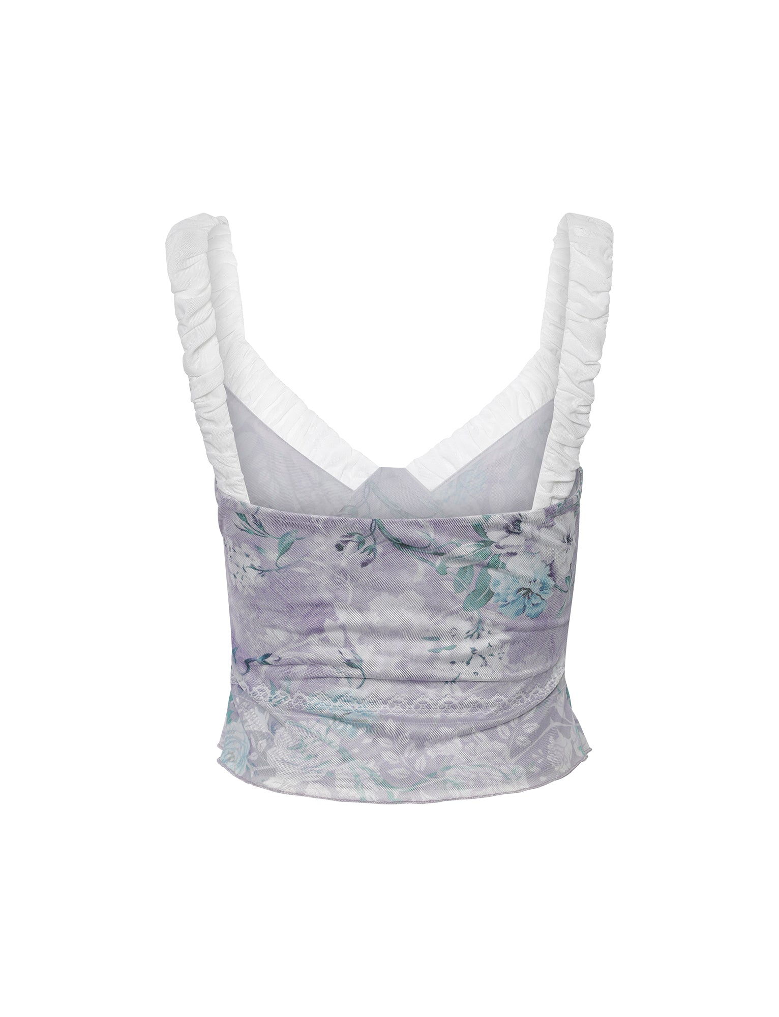 The AMARAN TOP - PURPLE: FLORAL BORDERS from TIGERMIST is a purple floral sleeveless crop top with white ruched shoulder straps. It features intricate floral patterns, a fitted waist, and a subtle lace trim at the bottom hem. The back is simple and elegant, showcasing the detailed fabric design.