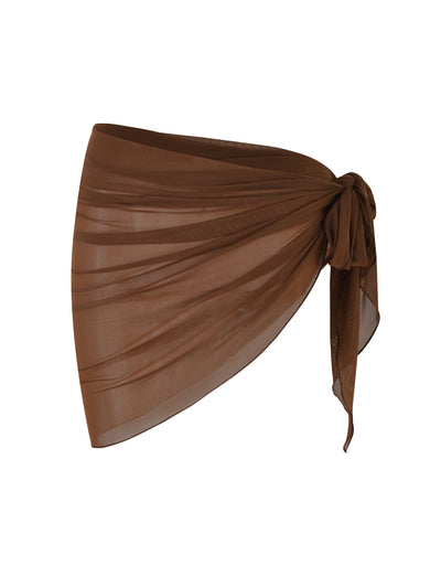 A brown, sheer PEACHY SARONG - BROWN : CHOCOLATE from TIGERMIST is elegantly tied in a bow on the right side. The fabric drapes softly, creating a flowing appearance. The sarong is displayed against a plain white background.