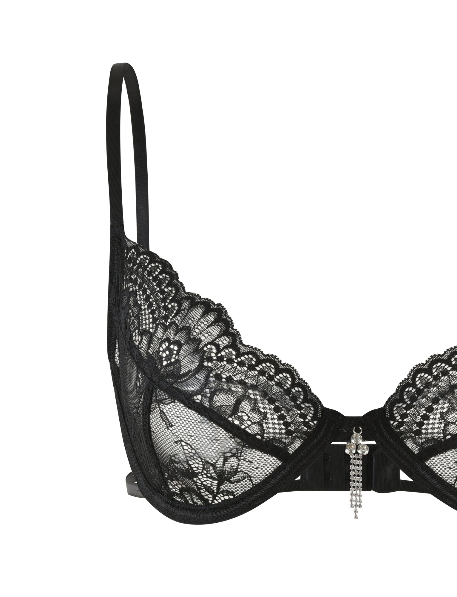 The JORDAN SET - BLACK by TIGERMIST is a sophisticated and alluring black lace intimate set, featuring a delicate floral-patterned bra with thin straps, a semi-sheer design, and an elegant rhinestone charm at its center.