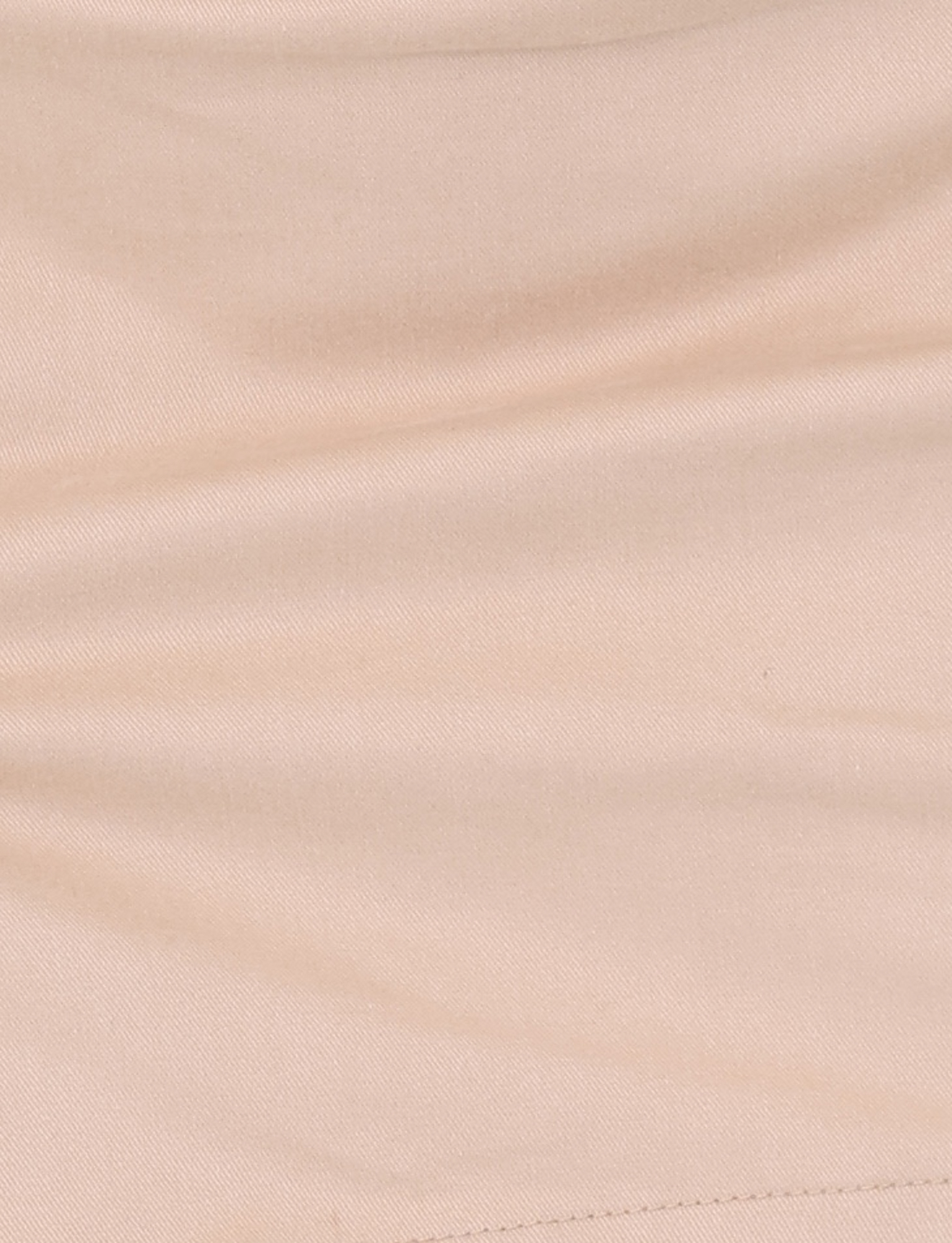 Close-up of the TIGERMIST KITTIE SKORT - TAN showcases its soft fabric, visible stitching, gentle creases, and mini length appeal.