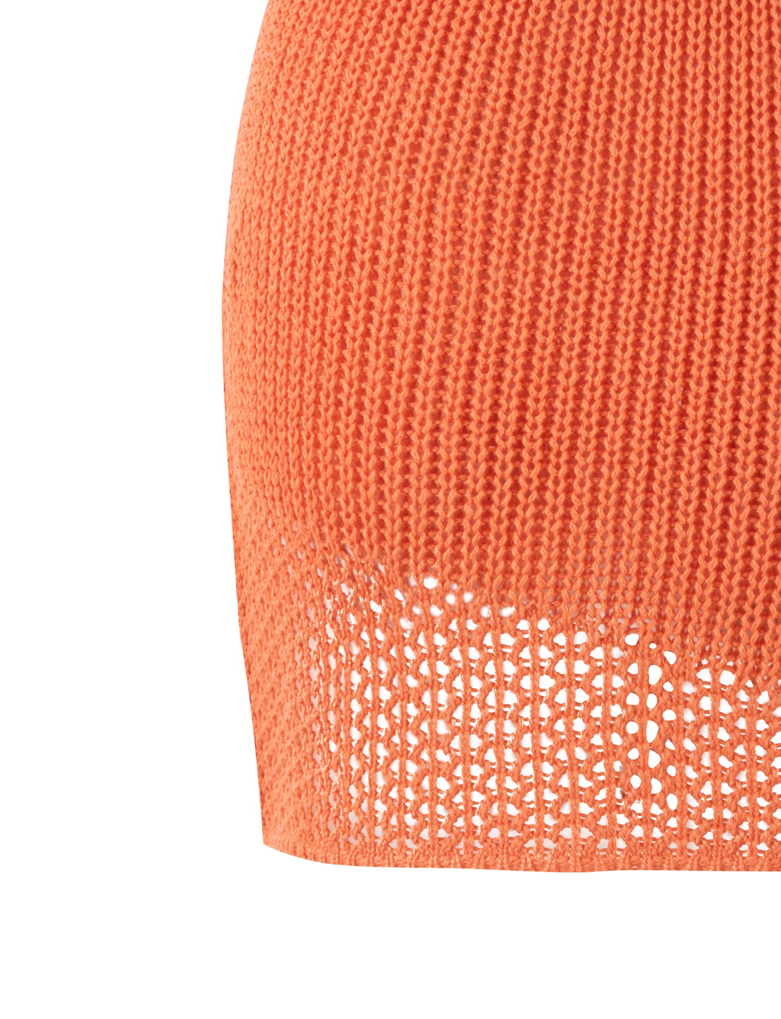 Close-up of an orange knitted fabric with a textured pattern, featuring a section of openwork holes near the bottom edge. The material appears to be part of the MACAULEY MINI SKIRT in ORANGE by TIGERMIST.
