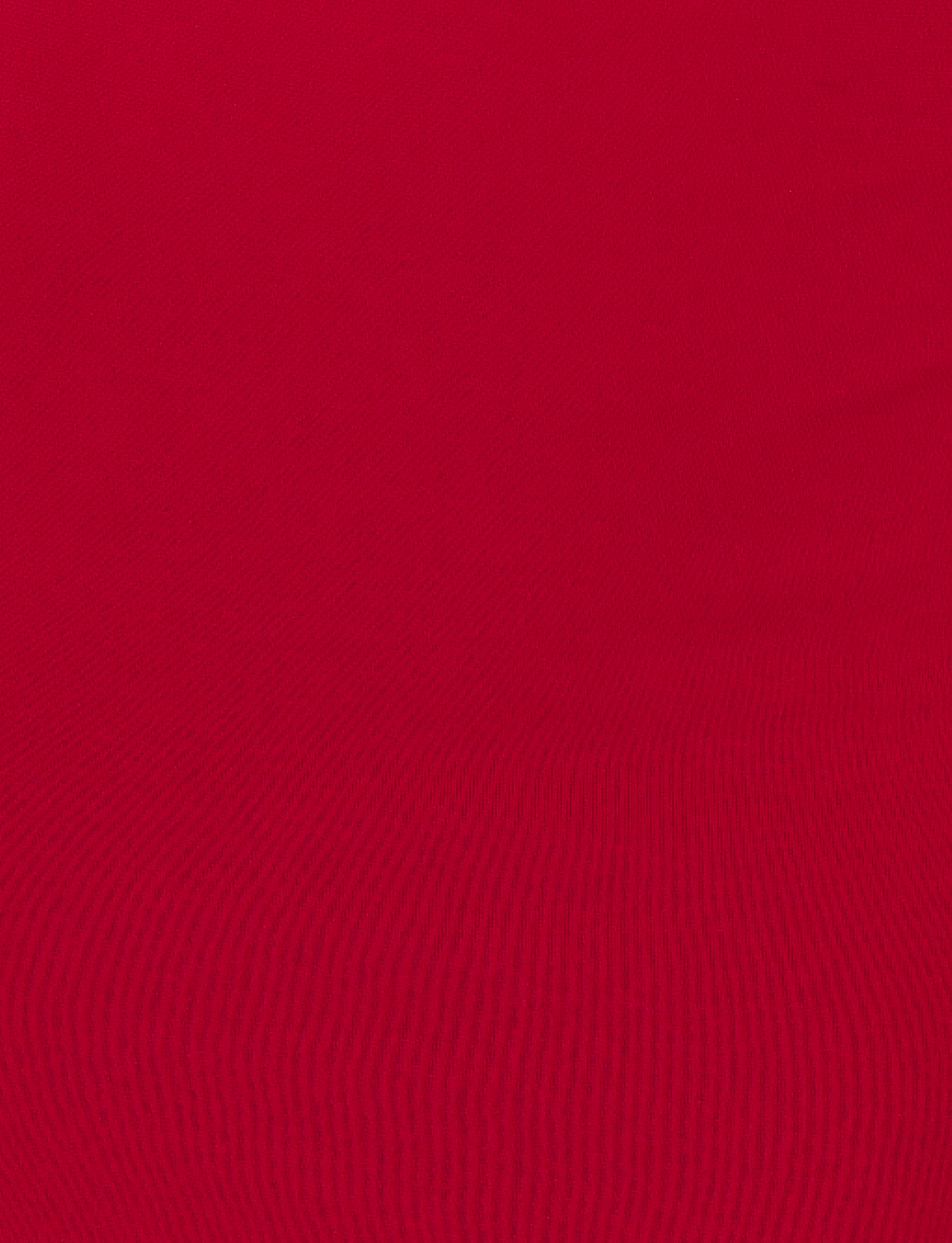 A close-up of the TIGERMIST MORANA MAXI DRESS - RED fabric, highlighting its textured lines and patterns that accentuate the dress's bodycon silhouette.