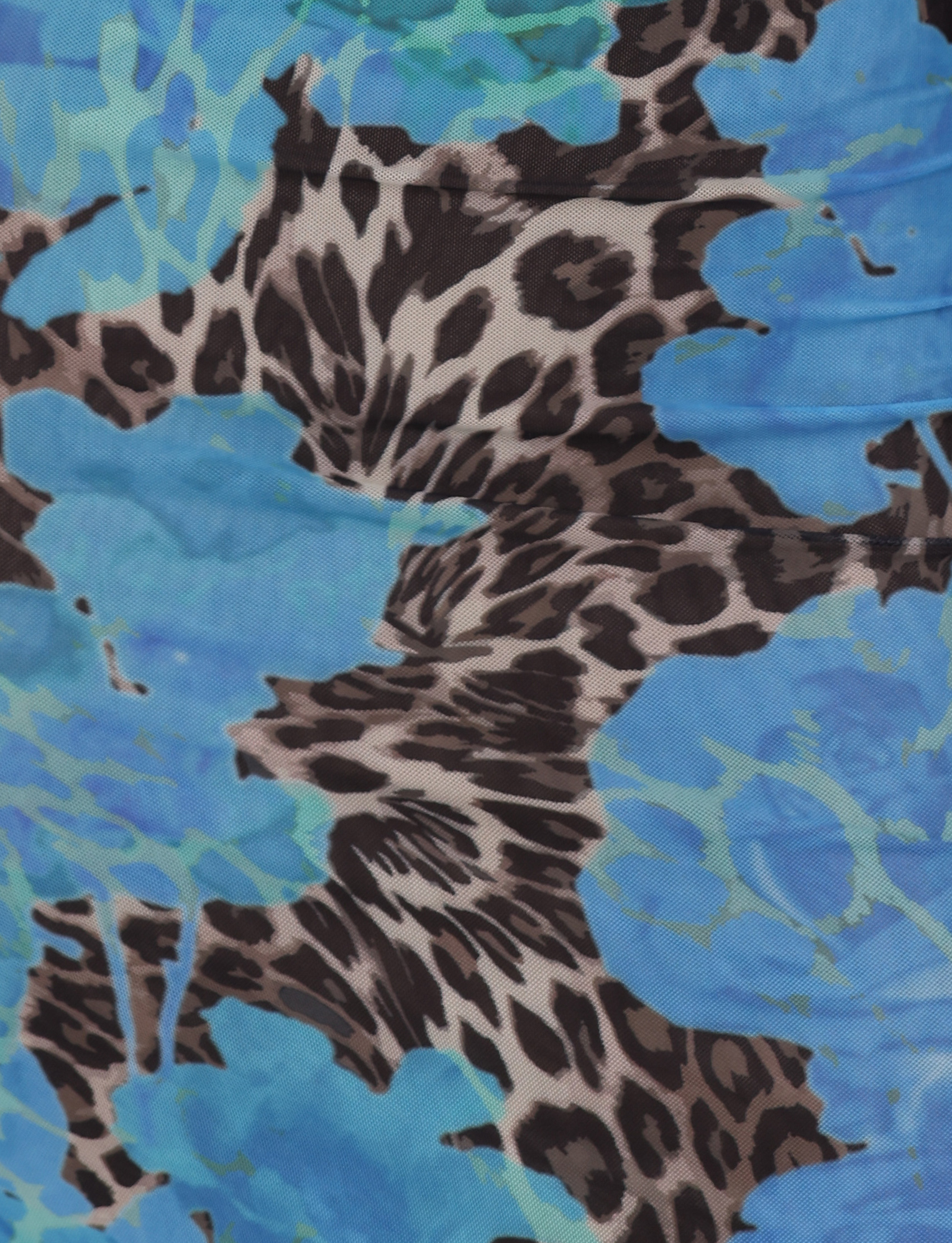Close-up of the JULIANNA DRESS - BLUE : LEOPARD by TIGERMIST, featuring a vibrant blue floral and leopard print. Ideal for making a statement with this bold, abstract-patterned dress or a striking maxi dress.