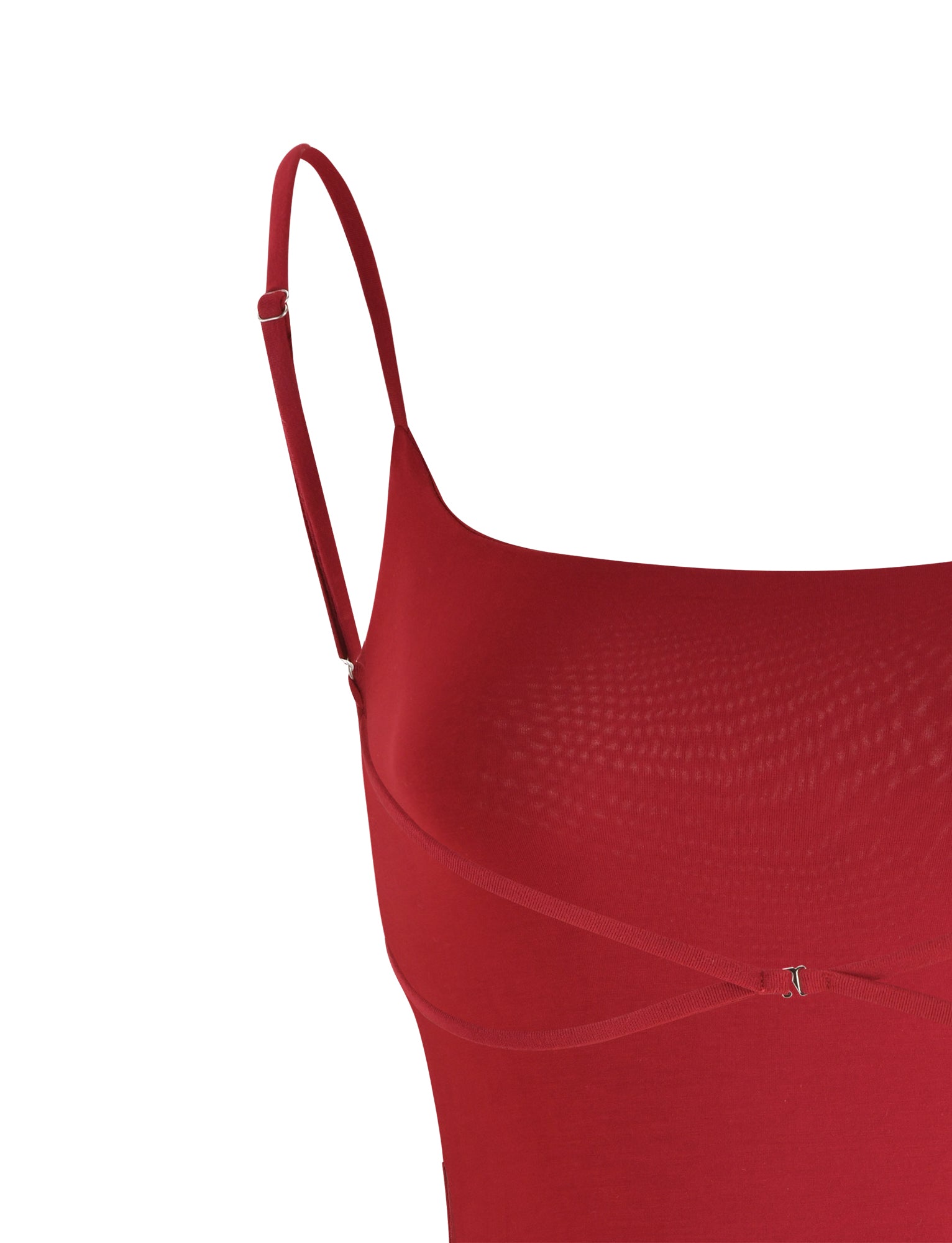 A close-up of the Minerva Bodysuit in red from TIGERMIST, showcasing its thin spaghetti straps and fitted design. The fabric looks smooth and slightly stretchy, creating a sleek appearance. The top portion features delicate strap adjustments.