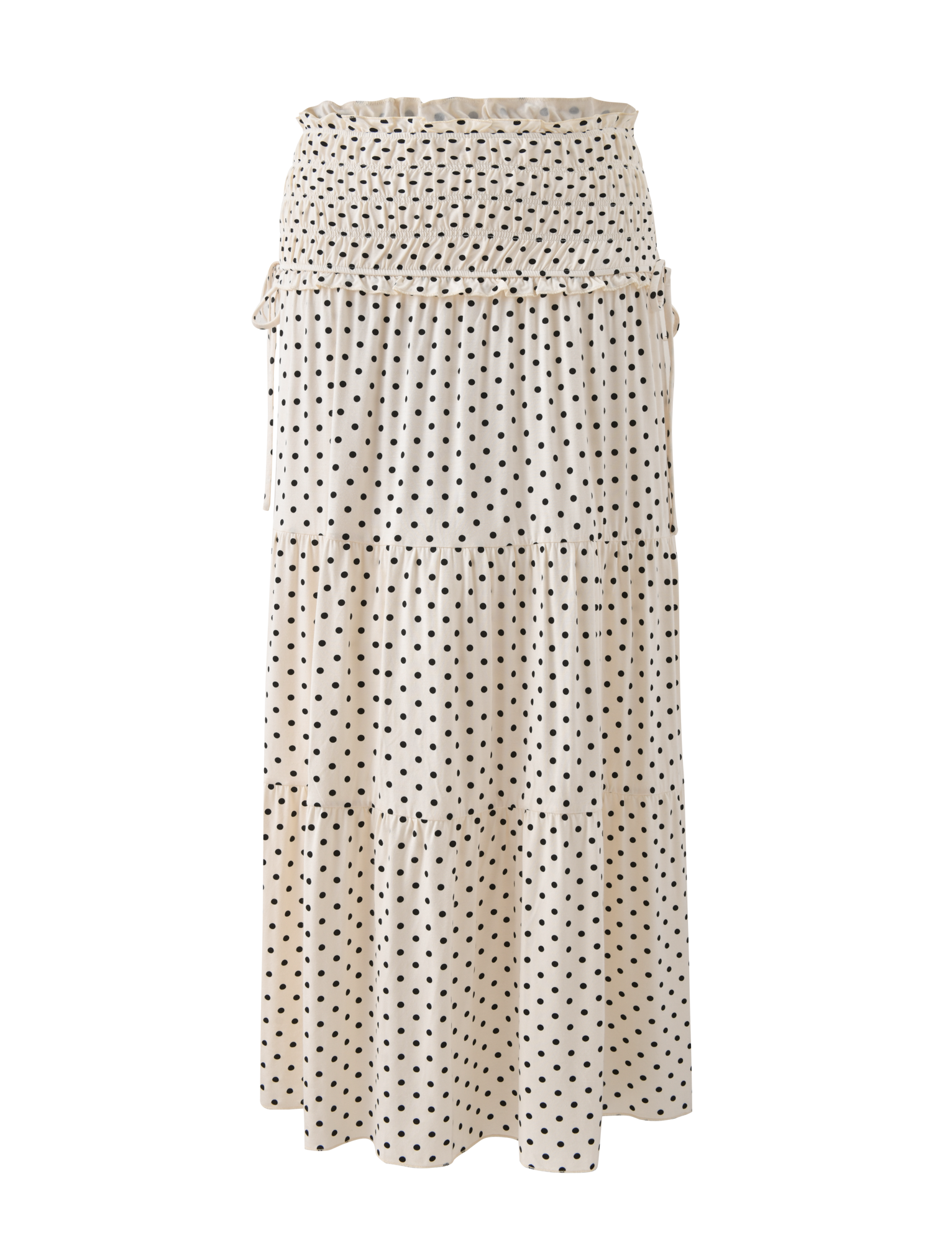 The DENALI MAXI SKIRT - CREAM DOT by TIGERMIST features a cream base with black polka dots, a smocked waistband, and a tiered silhouette—an effortlessly elegant maxi skirt for any occasion.