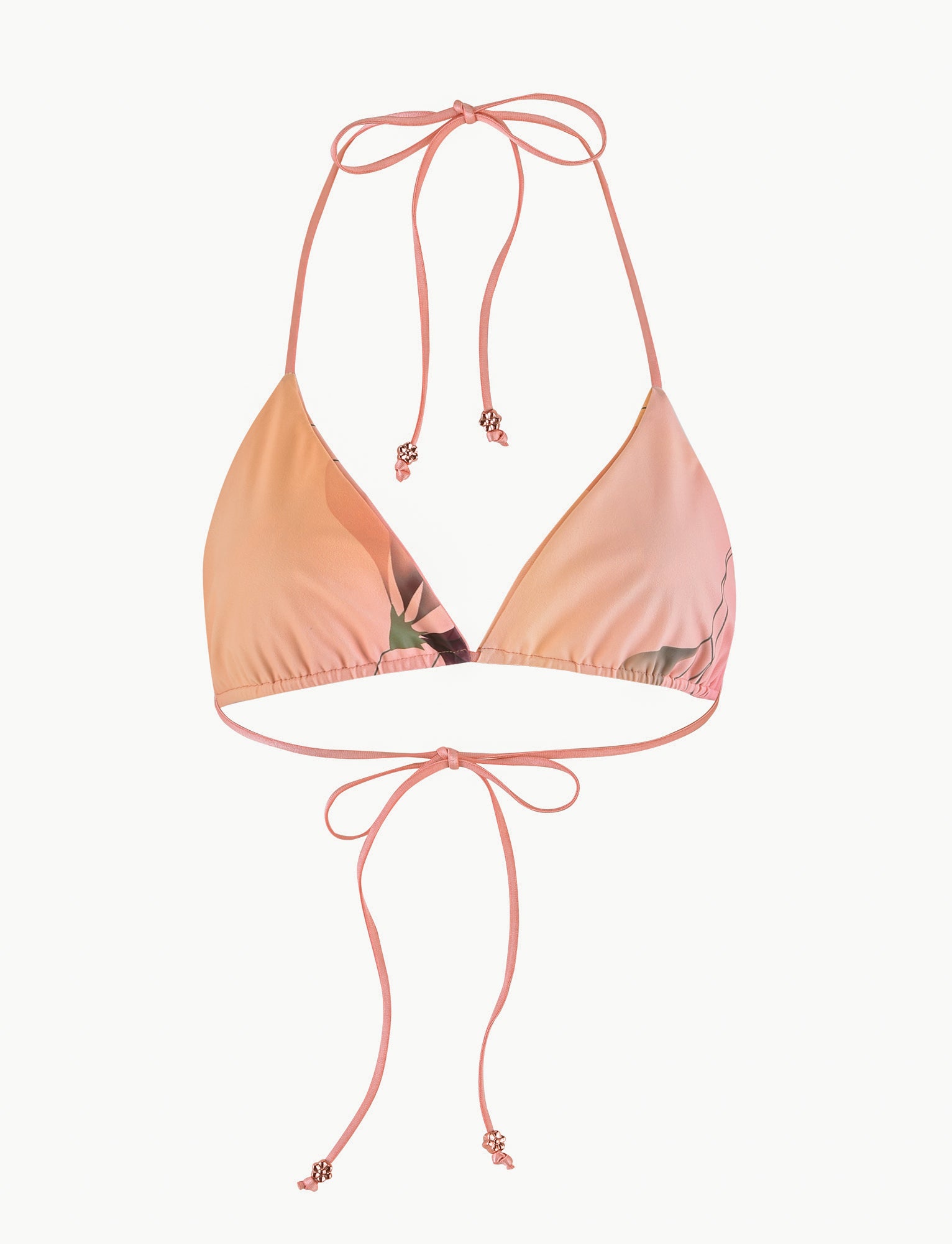 Introducing the TIGERMIST AVE Bikini Top in Multi, also known as the MACRO FLORAL: GRADIENT FLORAL. This stylish bikini top features a halter-neck design with triangular cups and tie closures at both the neck and back. Accentuated with small metallic beads at the ends of the ties, it showcases a beautiful gradient effect in shades of light pink to peach.