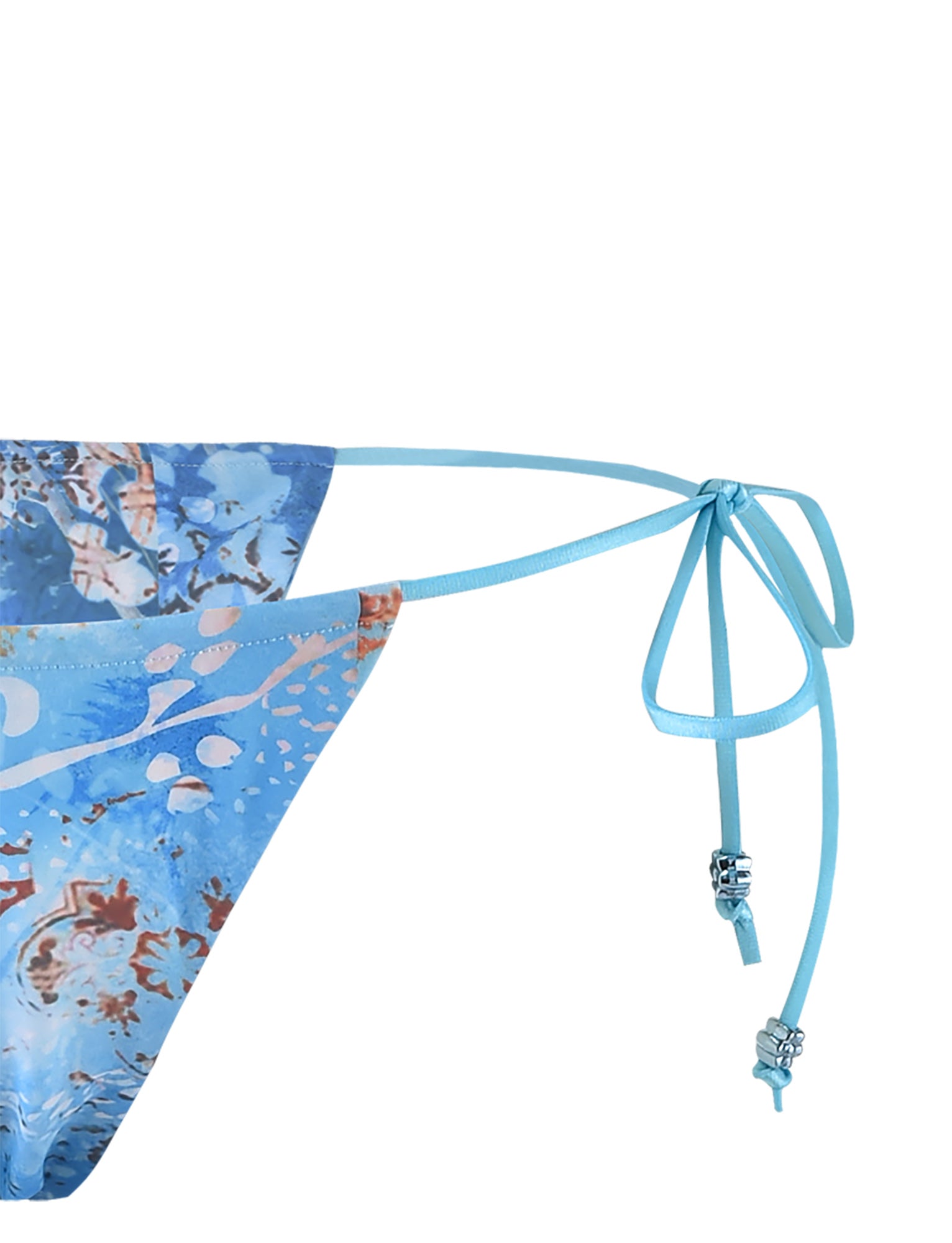 Close-up image of the AVE BIKINI BOTTOM - BLUE : TILE by TIGERMIST, showcasing its colorful abstract pattern. The bikini bottom features side string ties adorned with small decorative beads. The background is plain white.