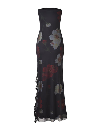 Introducing the THEO MAXI DRESS - RED : MACRO FLORAL from TIGERMIST. This strapless, floor-length dress showcases a form-fitting silhouette crafted from black fabric adorned with large white and red floral patterns. A side slit with lace detailing adds an elegant touch to the gown.