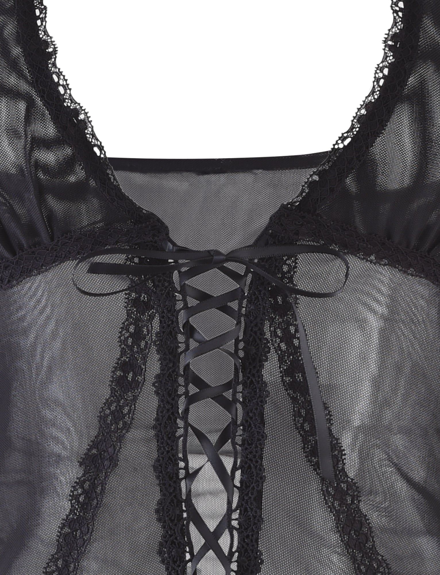 Close-up image of the KAYLEE TOP - BLACK from TIGERMIST. This black lace-up mesh top is adorned with intricate lace detailing along the edges and features a central ribbon threaded through eyelets, tied in a bow at the top. The texture and design suggest a delicate and intricate garment.