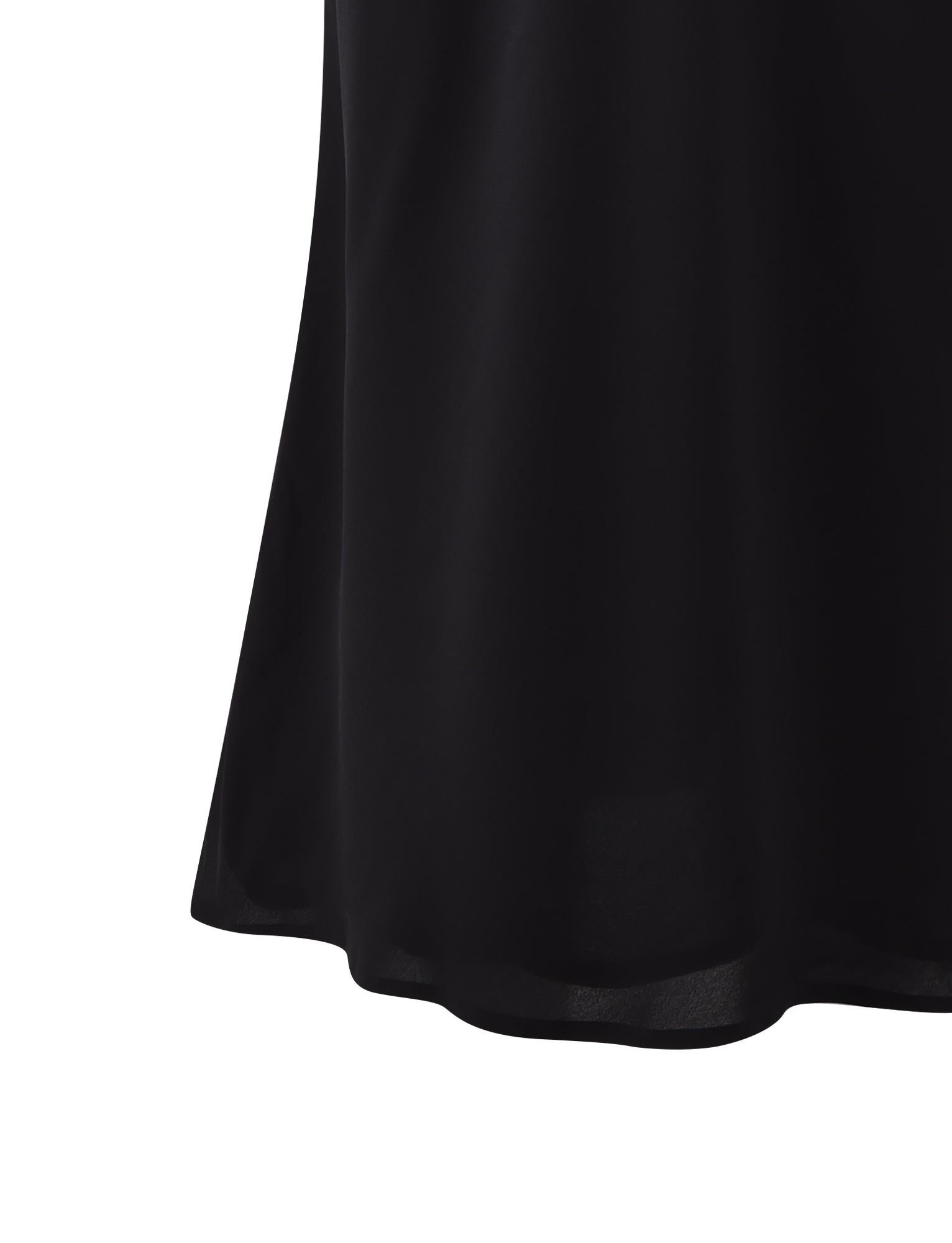 A close-up of the bottom part of the MOIRA SKIRT - BLACK from TIGERMIST, showcasing a smooth, slightly flared hemline in a soft and slightly shiny fabric.