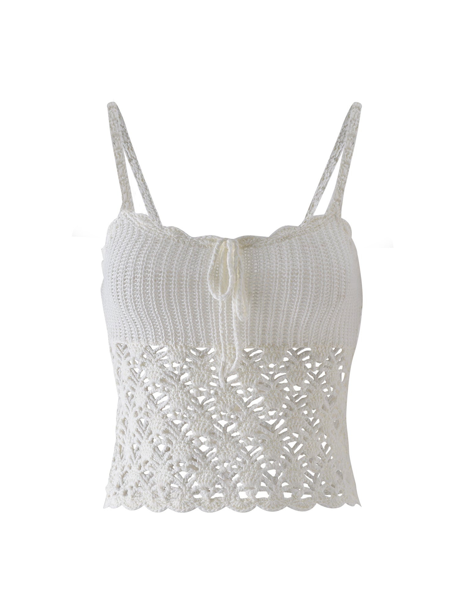 The RIKI TOP - WHITE from TIGERMIST is a white, crochet crop top with thin straps and a scalloped hem. The upper part features a tighter knit pattern, while the bottom section has an open, intricate lacy design. The front includes a small tie detail in the center.