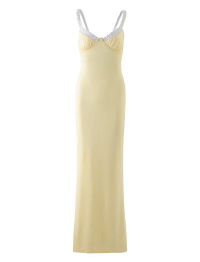 The AMARAN DRESS - YELLOW : LEMON from TIGERMIST is a long, sleeveless dress that features light-colored straps and a subtle sweetheart neckline, designed to be form-fitting. With its smooth texture, this dress embodies a simple and elegant style.