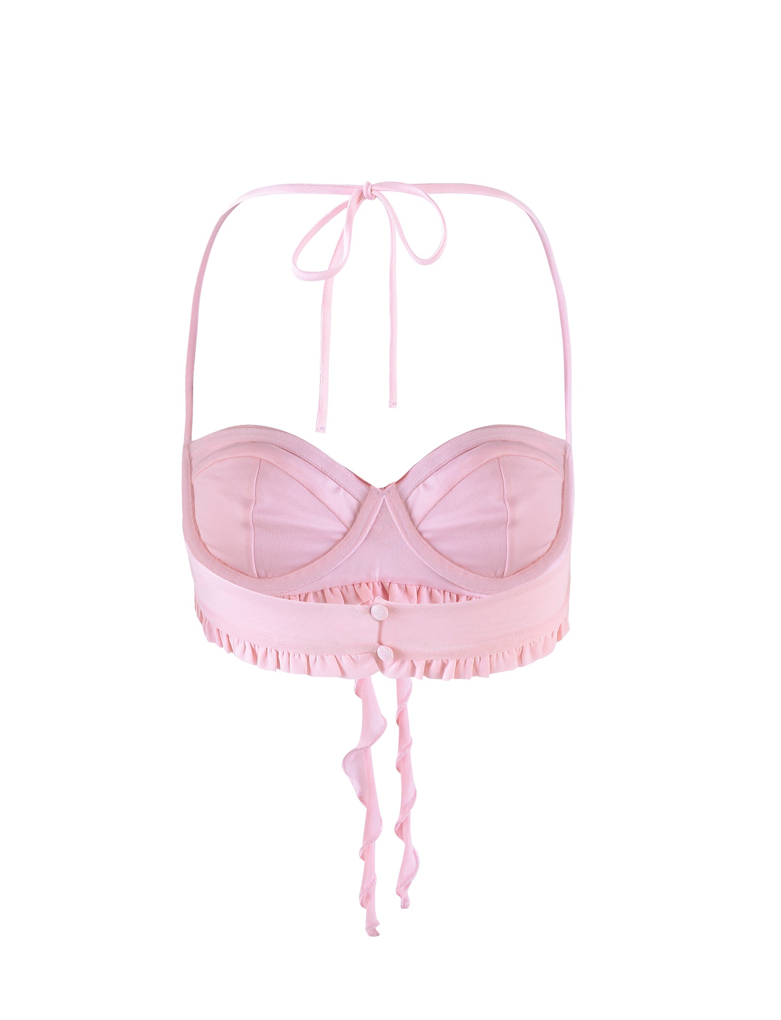 The HEAVEN TOP - PINK by TIGERMIST is a light pink halter-style bralette with padded cups and a ruffled band under the bust, featuring two buttons at the center front and ties at the back that create a bow with flowing straps.