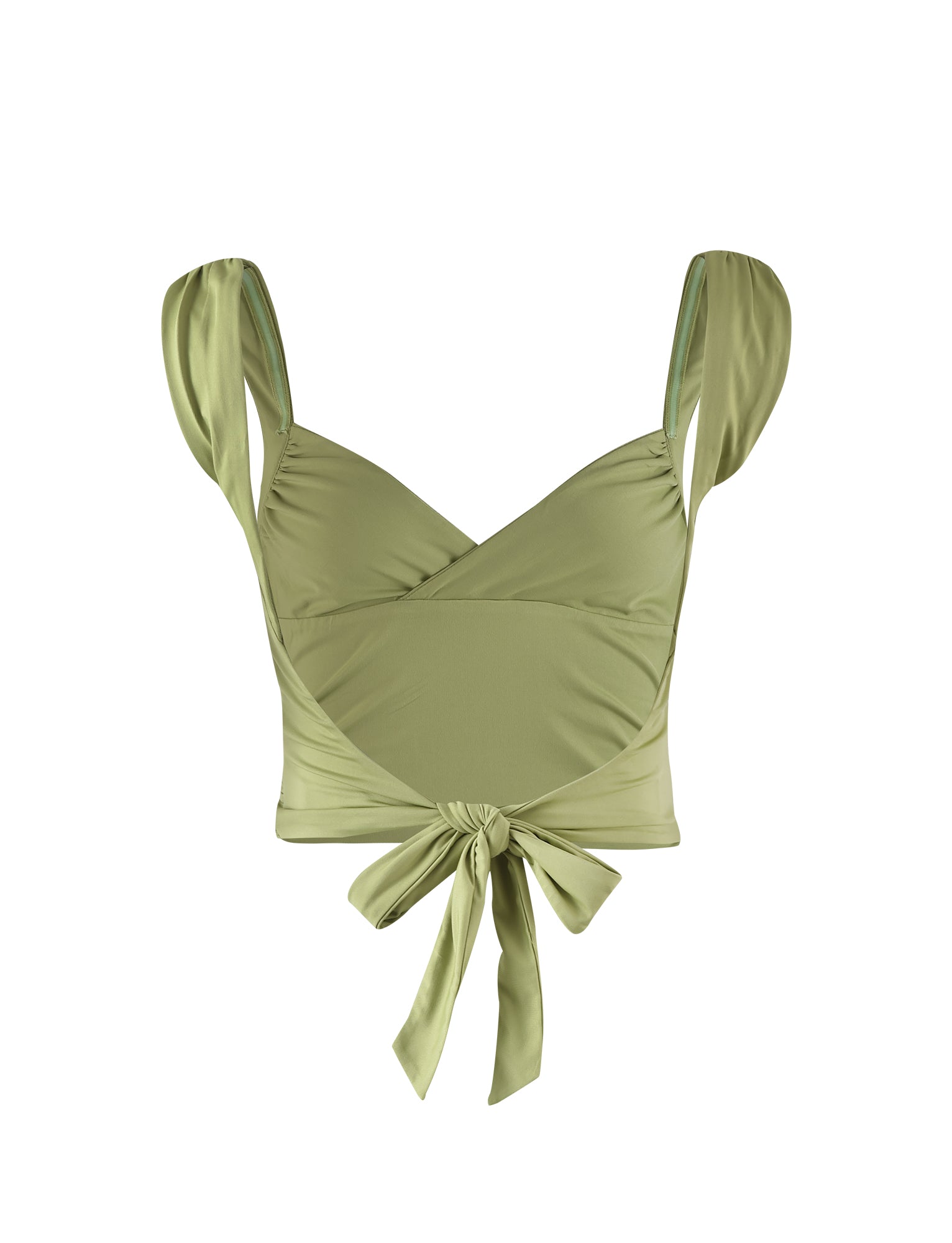 The MERA TOP from TIGERMIST comes in a matcha green, pale khaki shade. This light green, sleeveless crop top features wide shoulder straps and a stylish wrap-around design. The fabric crosses at the front and ties into a bow at the back, creating an elegant ruched effect on the sides. The material appears to be soft and stretchy.