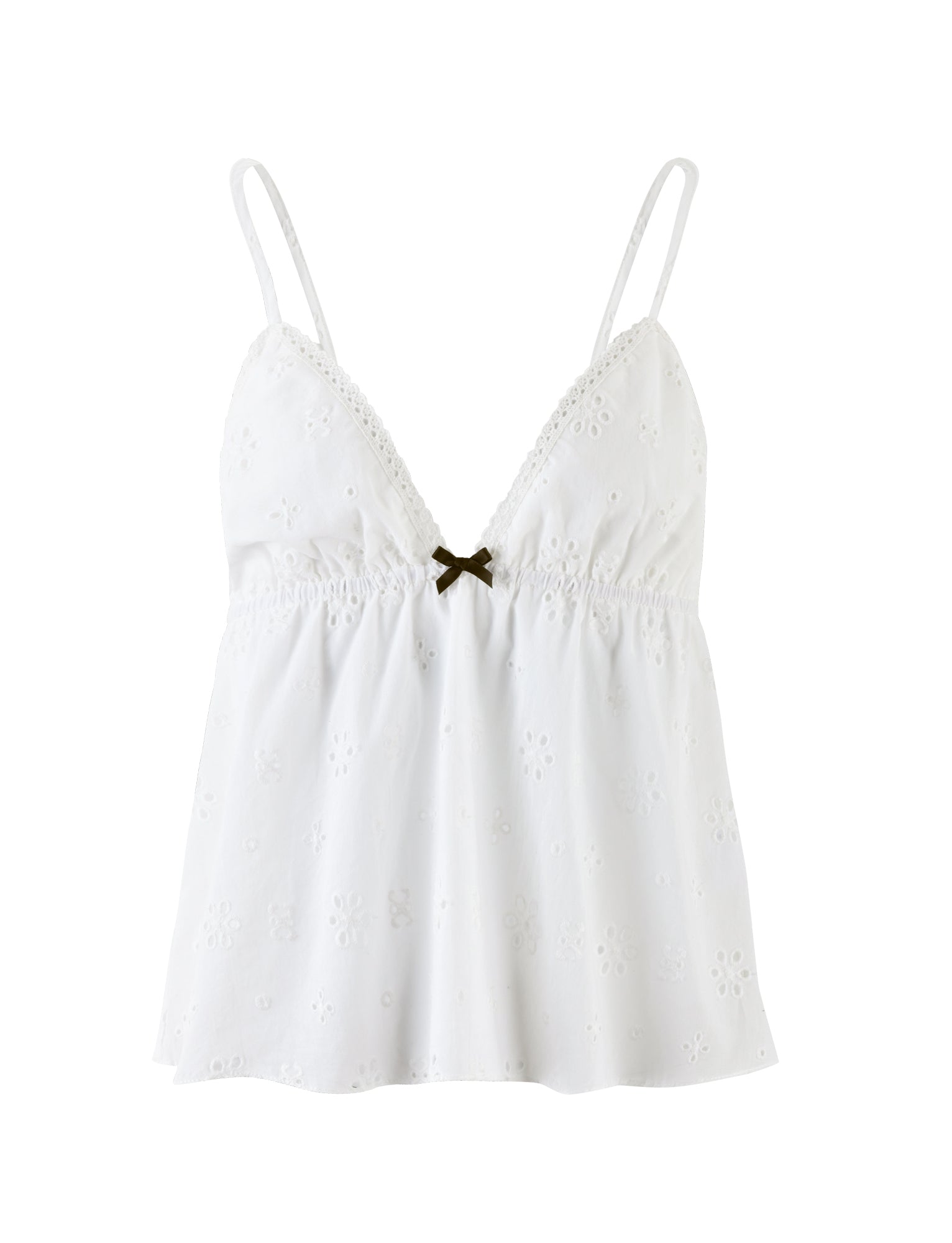 The MILANI TOP - WHITE from TIGERMIST is a white spaghetti strap camisole featuring a subtle floral eyelet pattern. It boasts a V-neckline, gathered detailing under the bust, and a small decorative brown bow at the center front. The fabric appears lightweight and airy.