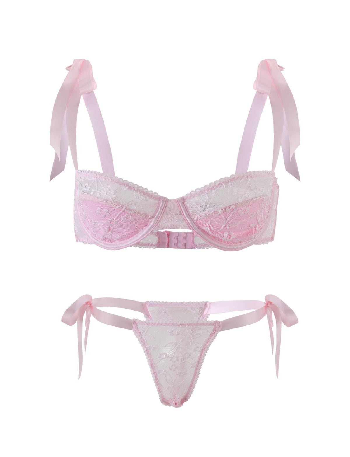 The SUGAR SET - PINK from TIGERMIST is a stunning pastel pink and white lace lingerie set. The bra showcases charming pink straps adorned with bows on the shoulders, complemented by intricate lace detailing on the cups. The matching panties feature delicate pink side ties and mirror the lace design in the front, giving both pieces a delicate, feminine appearance.