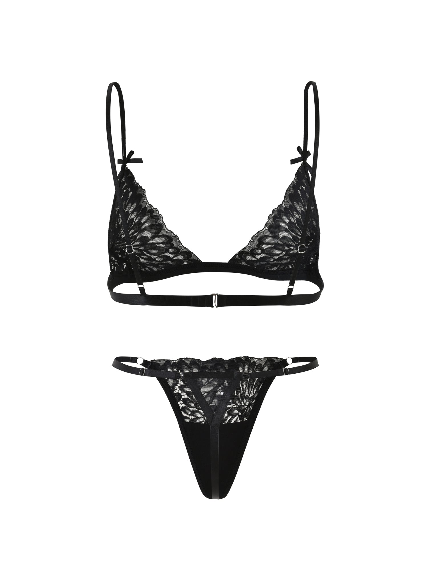 The BROOKE SET - BLACK from TIGERMIST is a black lace lingerie set that includes a bra and matching thong. The bra boasts delicate floral lace patterns, thin adjustable straps, and small decorative bows on the straps. The thong features a lace front with a thin elastic waistband.