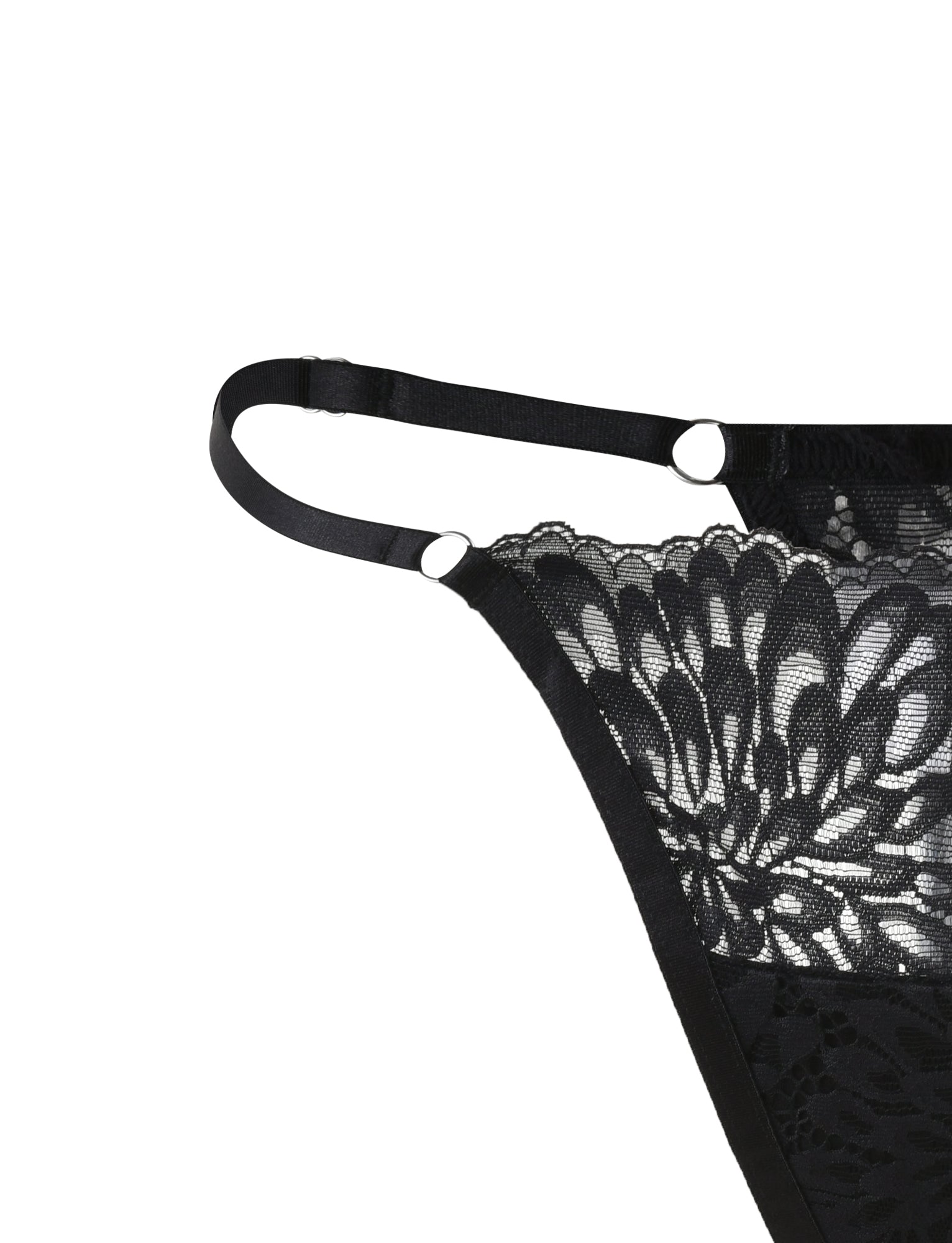 Close-up of the BROOKE SET - BLACK lingerie garment with intricate floral patterns by TIGERMIST. The piece features adjustable straps with metal rings for fastening. The delicate lace details enhance its elegant and sophisticated design.
