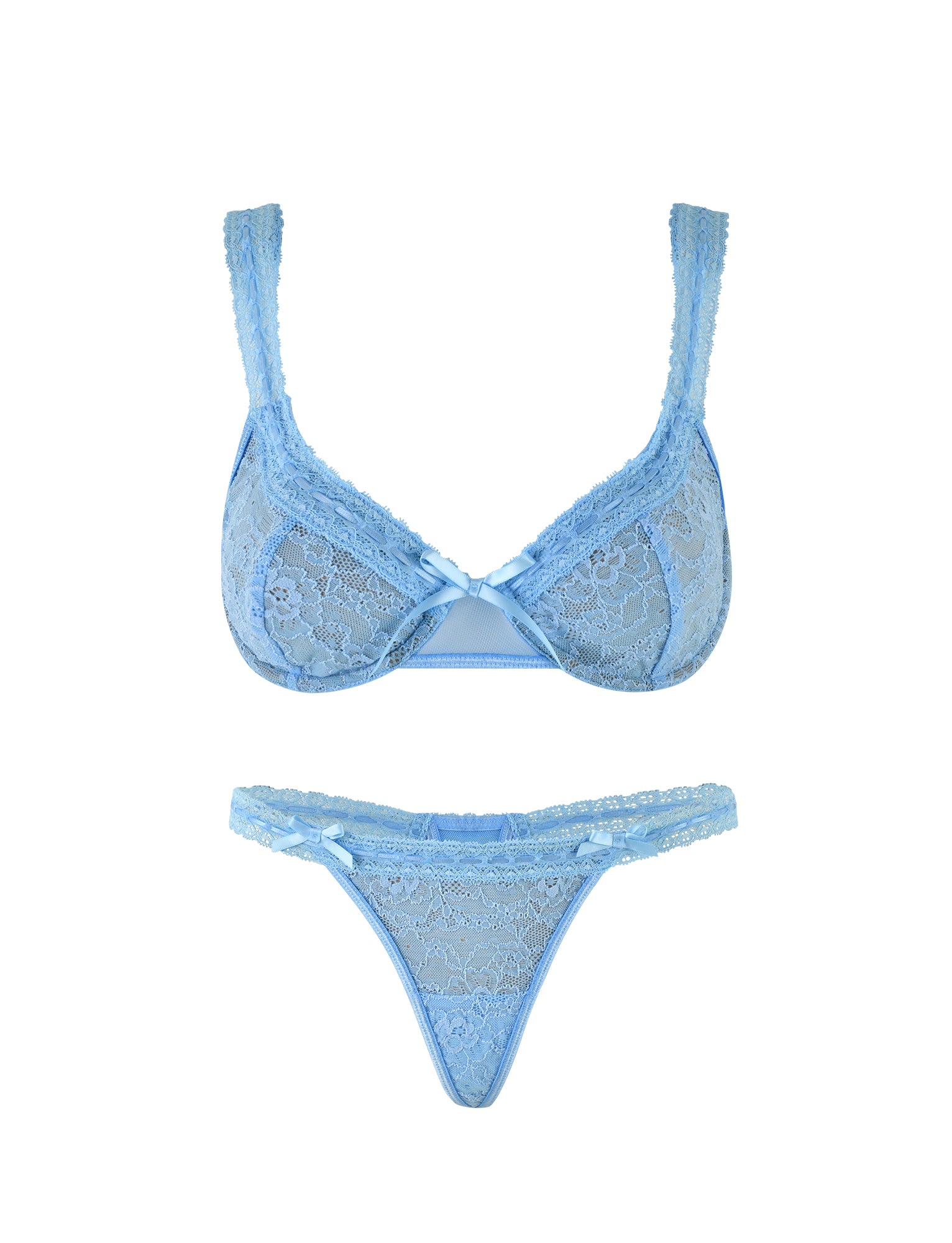 The PANDORA SET - BLUE by TIGERMIST is a matching ensemble of light blue lace lingerie, featuring intricate lace detailing and small satin bows at the center of the bra. The thong, made with sheer mesh and complementary patterns, also has a matching bow at the front. Both pieces are delicate and feminine in design.