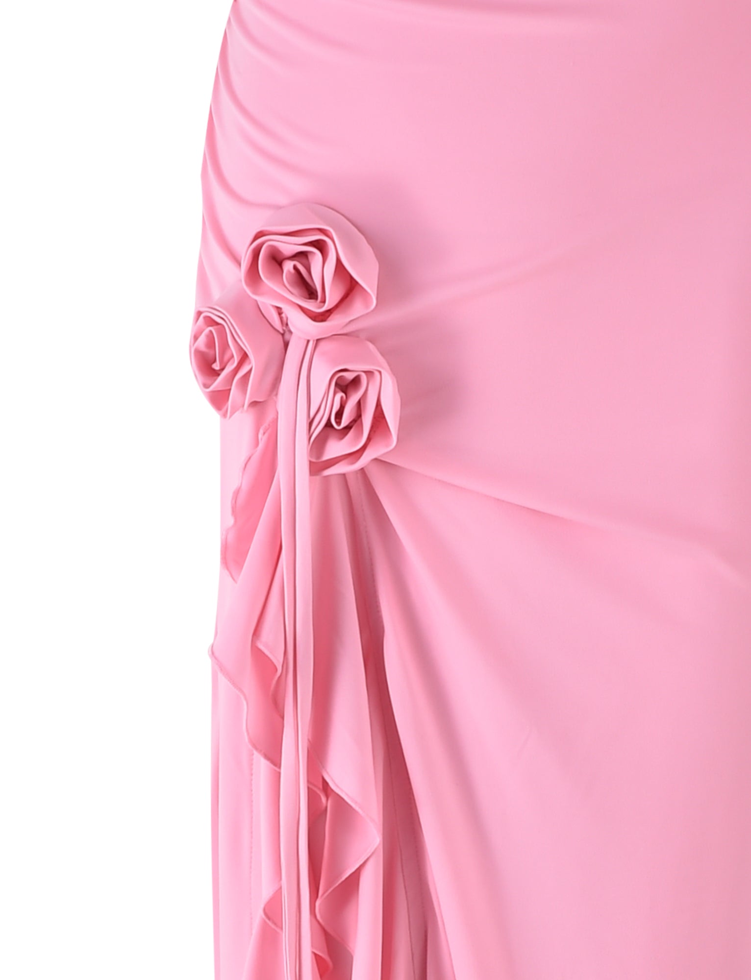 Close-up of the FAORA DRESS - PINK from TIGERMIST featuring three roses made from the same fabric, attached in a vertical arrangement. The material and roses create a soft, elegant drape against a plain white background.