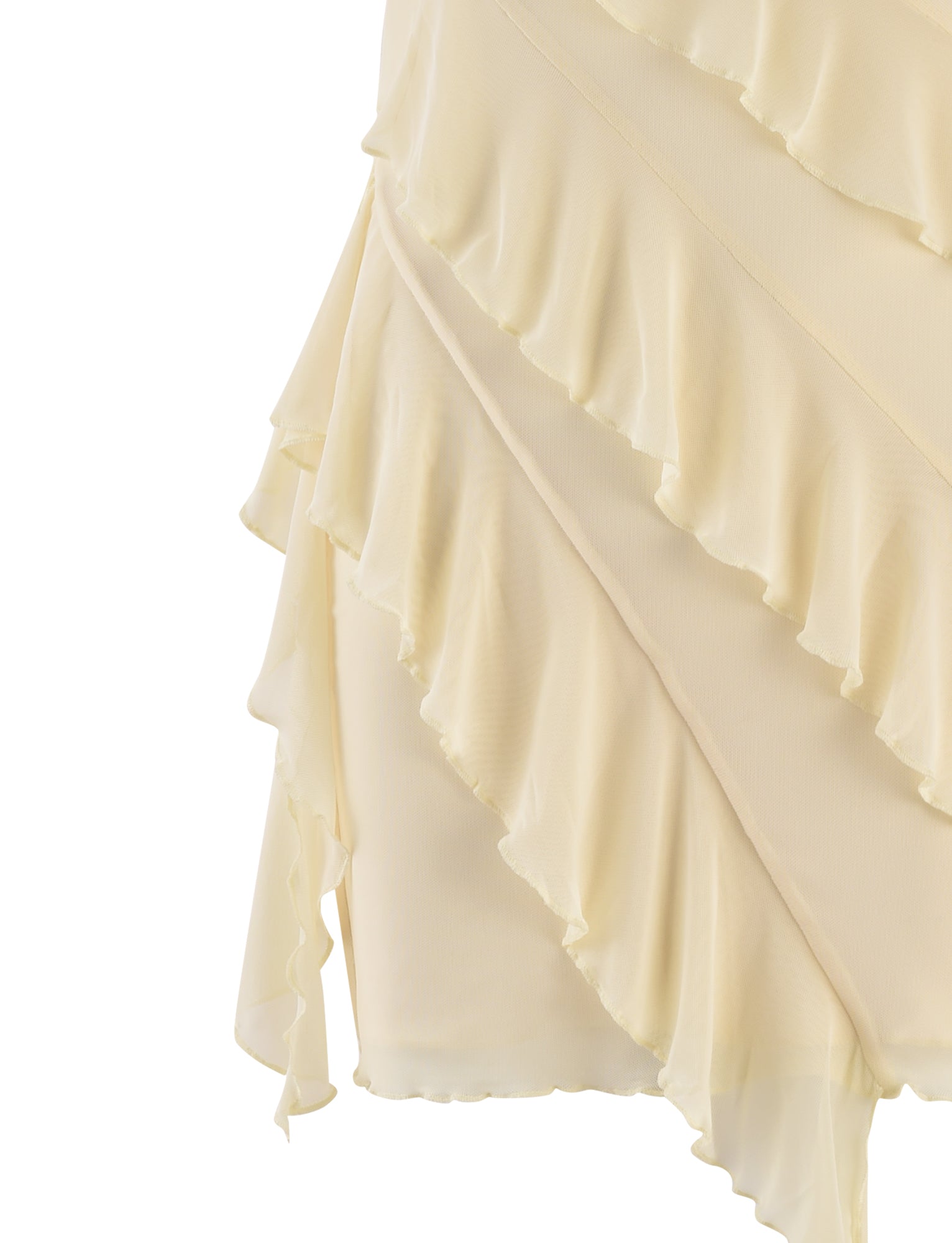 Close-up of the SADIA DRESS - YELLOW : BUTTER from TIGERMIST, showcasing a light beige, textured fabric with layered, ruffled edges. The lightweight and slightly translucent material features diagonal ruffle lines that overlap each other, creating an elegant and delicate design.