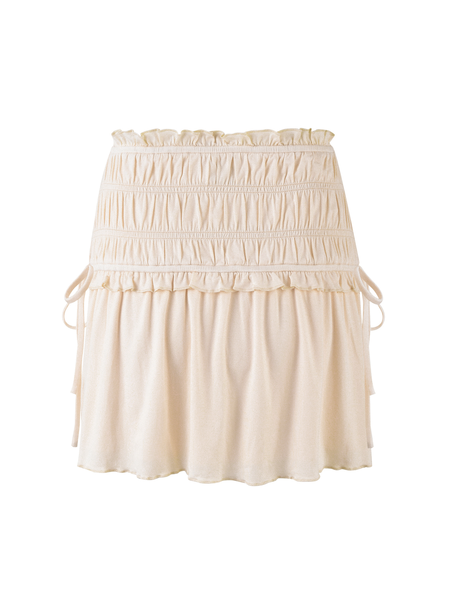 The TIGERMIST DENALI MINI SKIRT - WHITE : BONE is a cream-hued mini skirt in soft jersey, featuring a smocked waist with ruffle trim, adjustable side ties, and a loosely gathered, flowy silhouette.