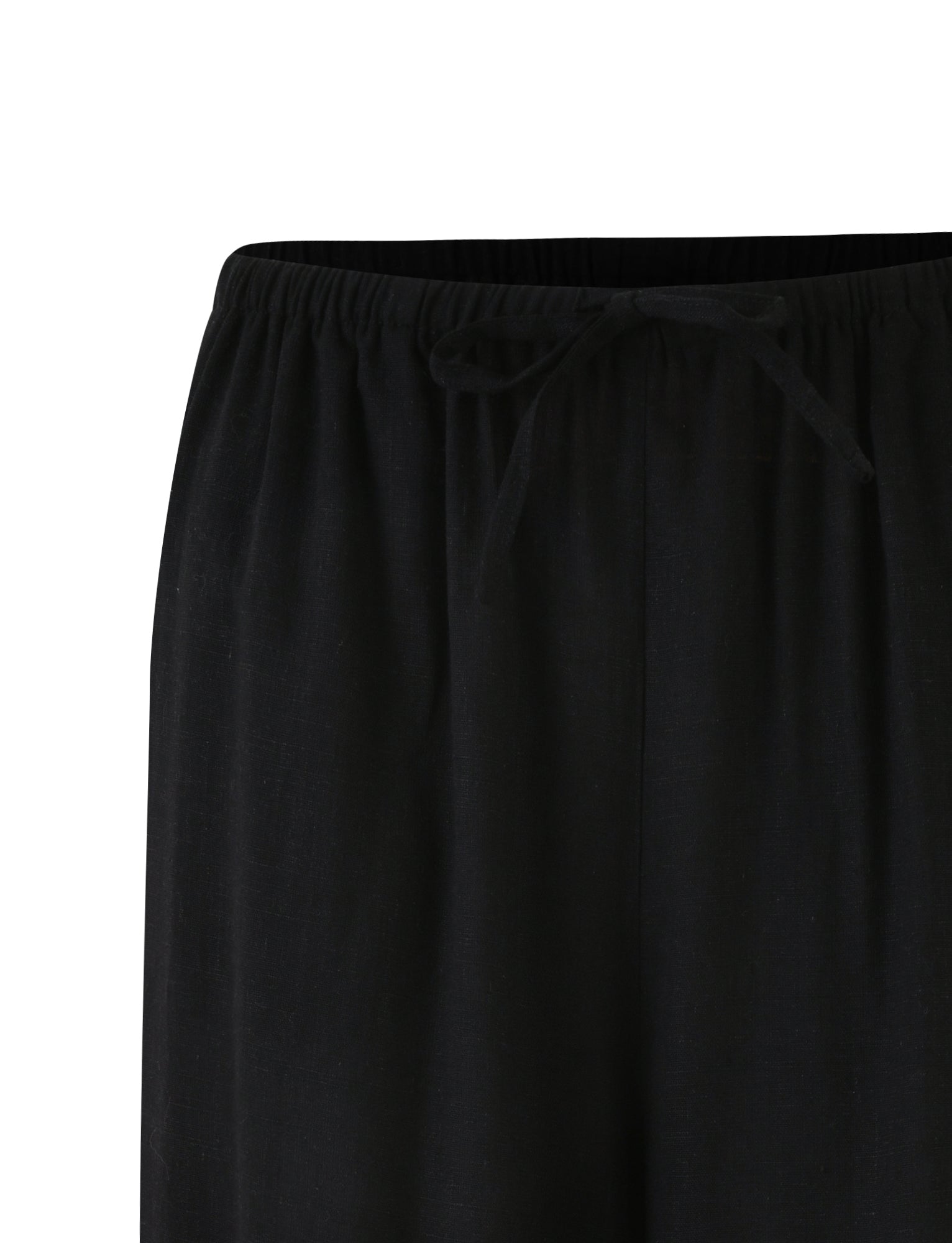 Close-up view of the waistband of a pair of black LAINEY PANT by TIGERMIST, featuring a drawstring tie in the center. The fabric appears lightweight and comfortable.