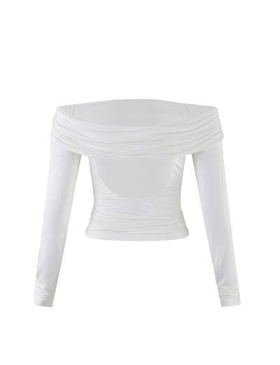 The INDIANA TOP - WHITE by TIGERMIST is a white, long-sleeved, off-the-shoulder top featuring a gathered, draped design across the chest and shoulders. The fitted fabric around the torso creates a stylish and elegant look.