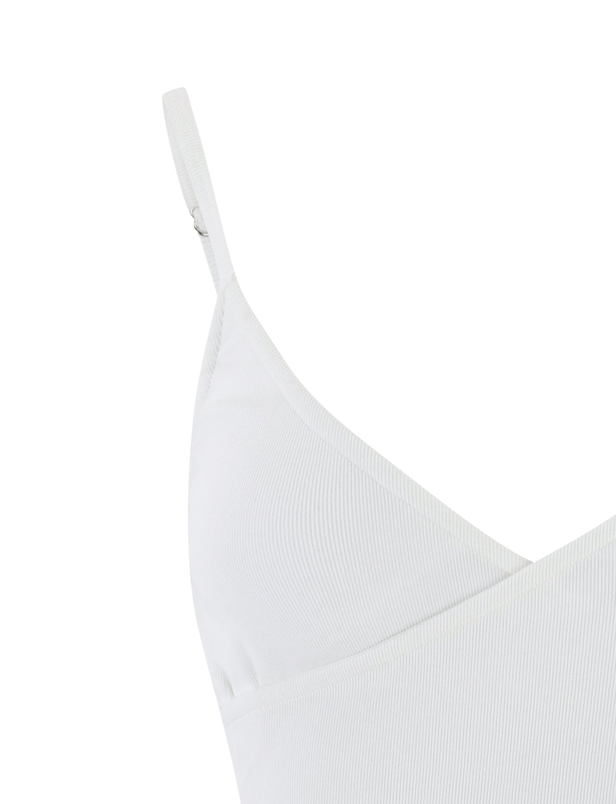 Close-up of the TIGERMIST REY TOP - WHITE camisole with thin straps and a V-shaped neckline. The fabric appears to be ribbed, and the image focuses on the upper left side of the garment, showing part of the shoulder strap and the seam detailing.