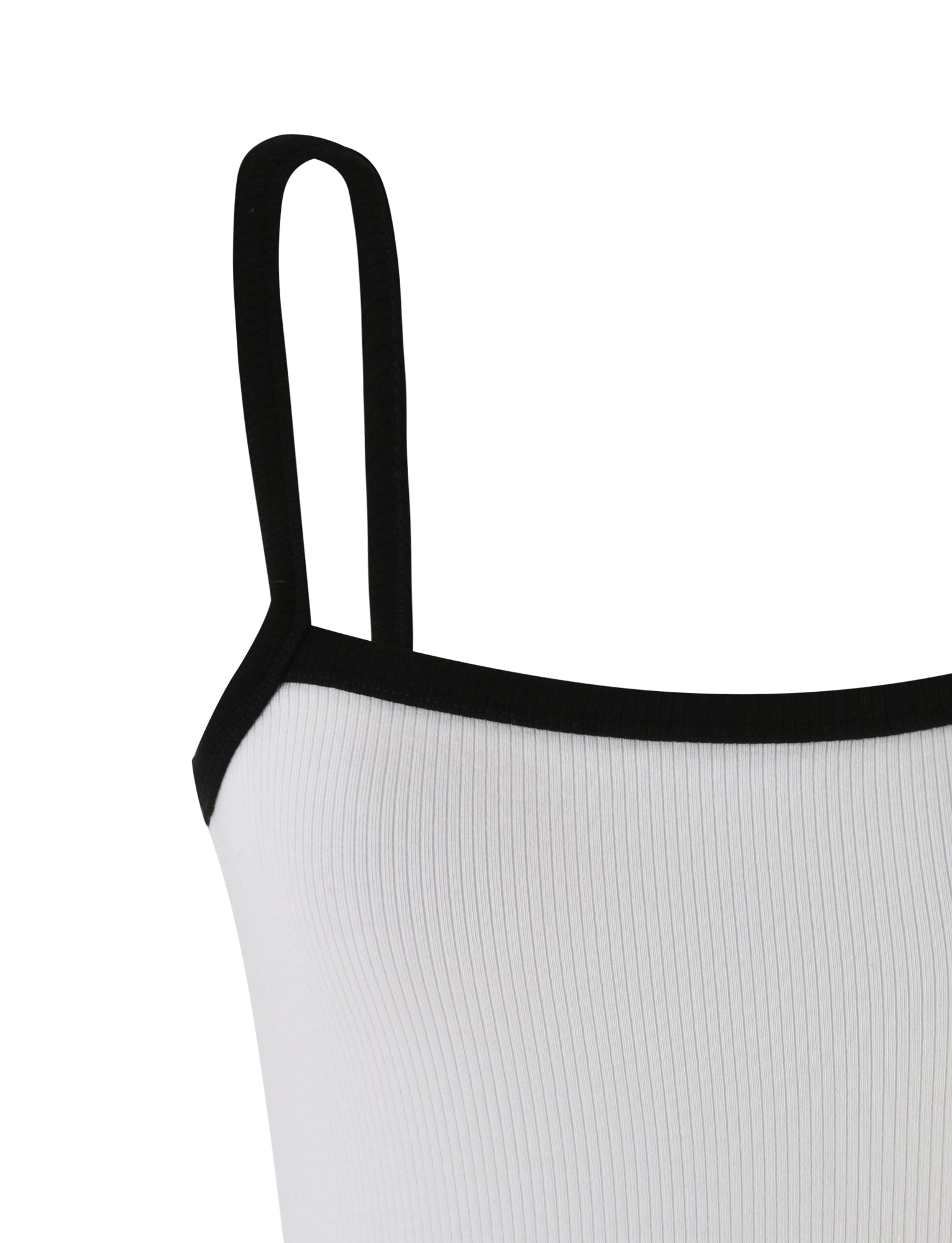 Close-up of the Nixie Top - White by TIGERMIST, featuring an off-white ribbed design with black trim around the neckline and straps. The visible portion showcases one of the shoulder straps and part of the upper chest area, highlighting the striking contrast between the off-white fabric and black edging.