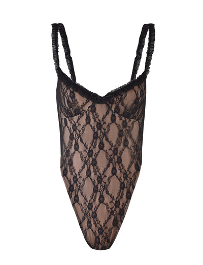 The DEJA BODYSUIT - BLACK by TIGERMIST is displayed against a white background. This black lace bodysuit showcases thin, ruched shoulder straps and a delicate floral lace pattern throughout, providing a semi-sheer look.