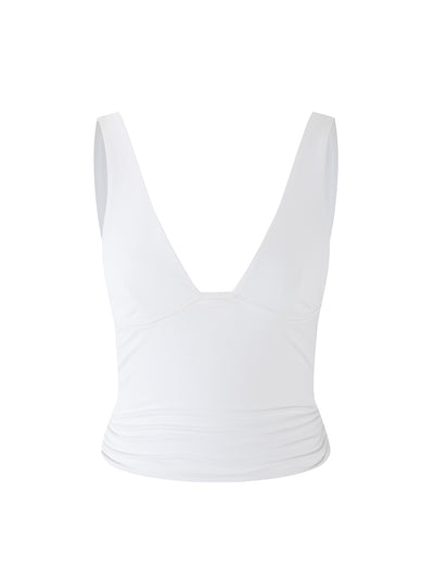 Introducing the LUNARIA TOP - WHITE by TIGERMIST: This stylish piece features a sleeveless V-neck design with a fitted waist and slightly pleated sides. Made from a slightly stretchy material, it offers a smooth and snug fit, embodying Tigermist's signature flair for chic yet comfortable fashion.