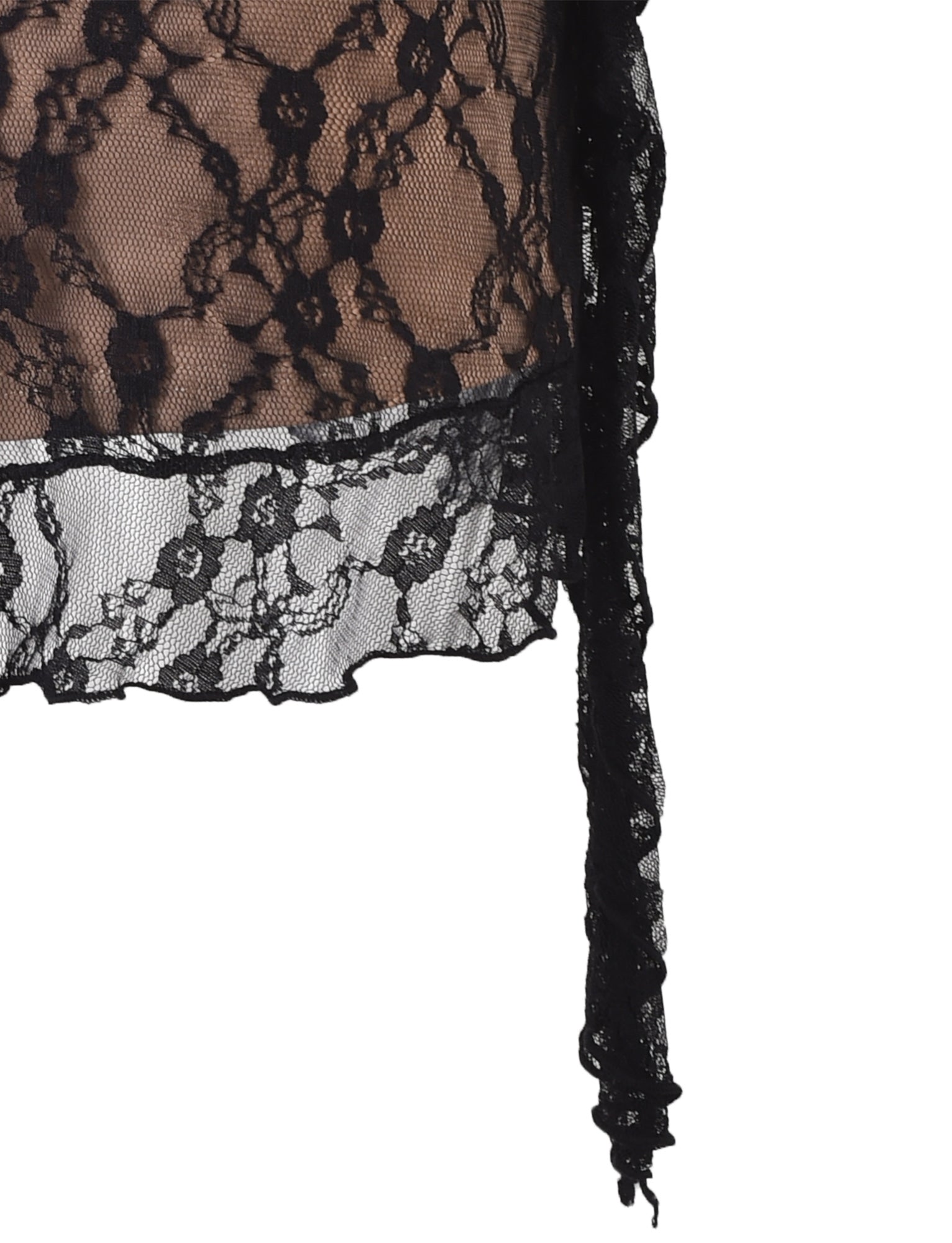 A close-up view of the TIGERMIST STORMI LACE SKIRT in black lace fabric, featuring a floral pattern. The semi-transparent material is shown draped over a beige background, with a loose, jagged edge elegantly hanging down.
