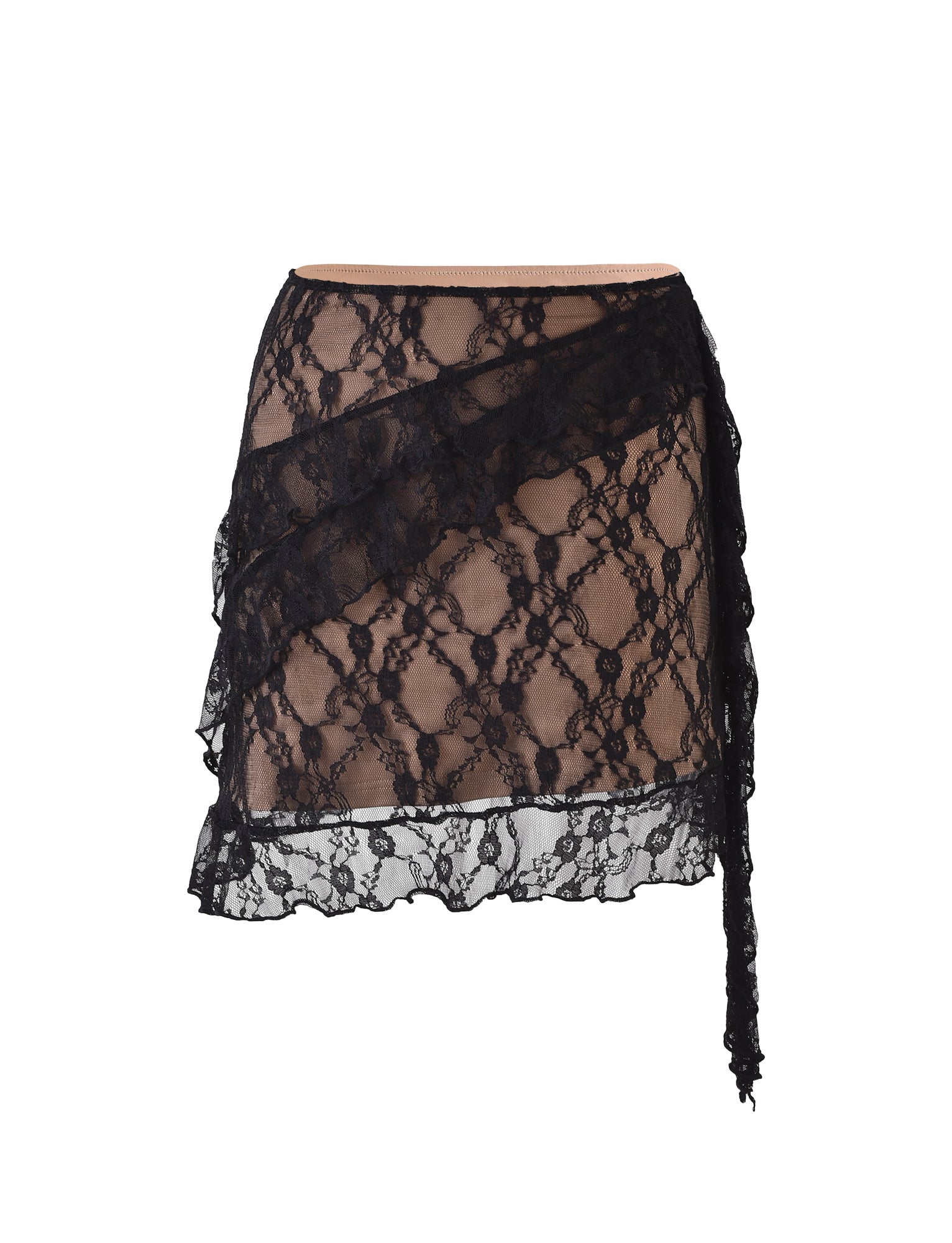 The STORMI LACE SKIRT - BLACK by TIGERMIST showcases black lace fabric with a diagonal ruffle overlay. Its intricate floral lace design offers a sheer look, enhanced by a nude lining beneath. An elegant long strip of lace hangs from the ruffled section.