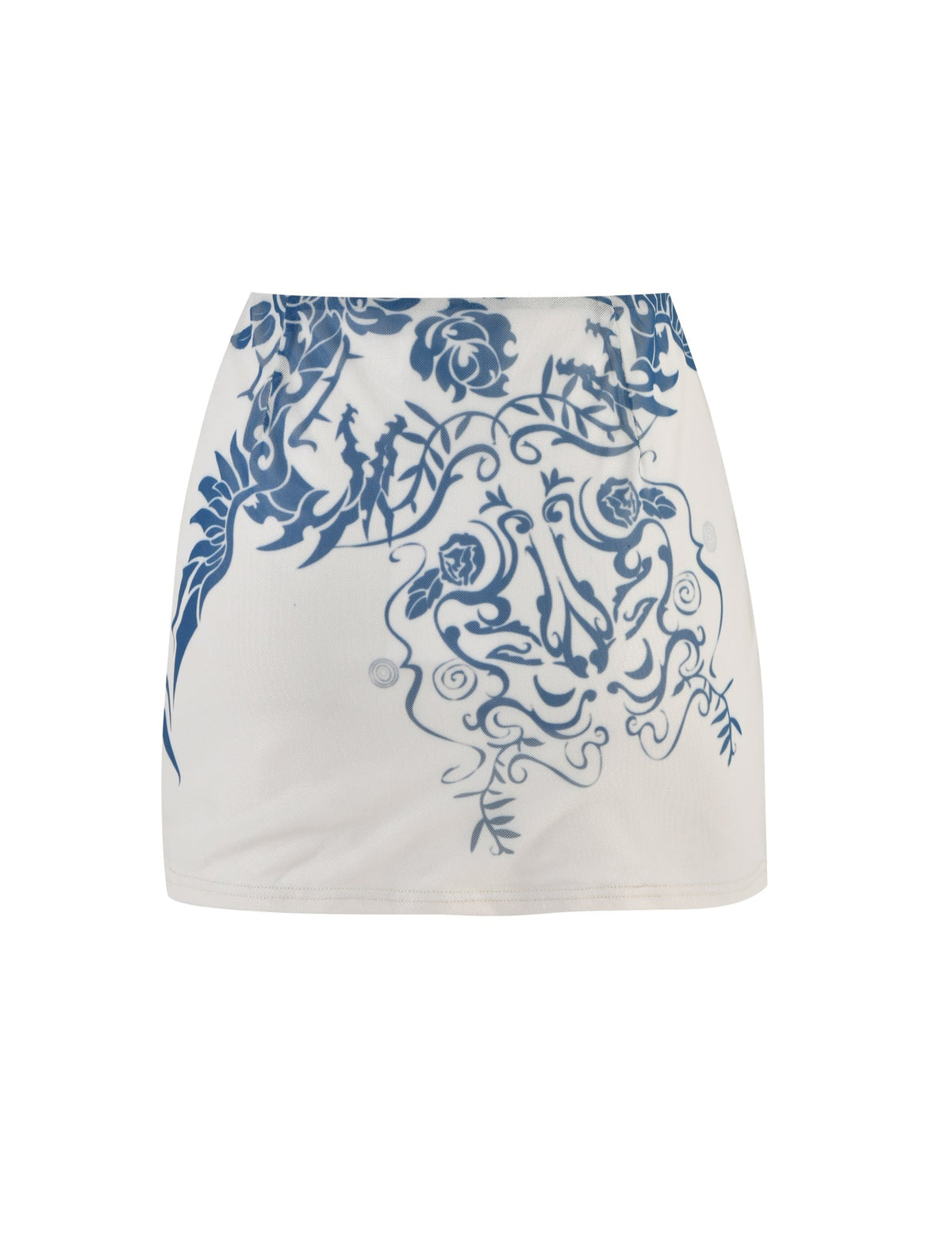 The FINOLA MESH MINI SKIRT - BLUE : TATTOO : TATTOO PRINT from TIGERMIST is a white skirt adorned with an intricate blue floral and vine pattern, prominently displayed on the right side and center. The design incorporates detailed swirls, leaves, and roses to create an elegant decorative look. This knee-length skirt is crafted from smooth fabric for a refined finish.
