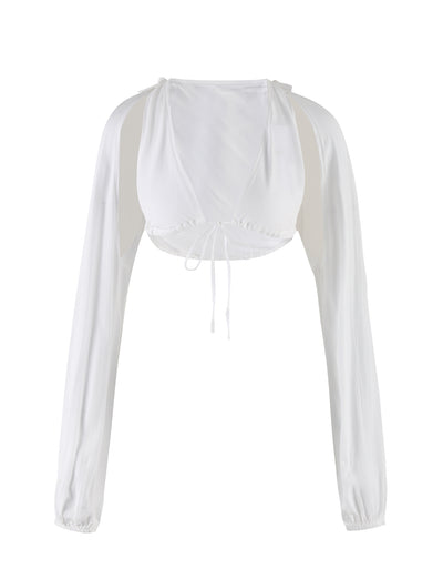 Introducing the Phillipa Top in white from TIGERMIST, a stylish cropped blouse with long sleeves, a deep V-neckline, and a tie closure at the front. The lightweight and airy fabric makes it perfect for warm weather.