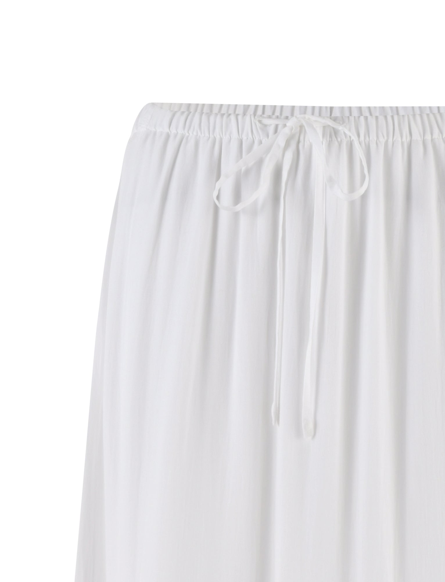 A close-up view of the PHILLIPA SKIRT - WHITE from TIGERMIST, showcasing its gathered elastic waistband with a drawstring tied in a bow. The fabric appears lightweight and slightly pleated.