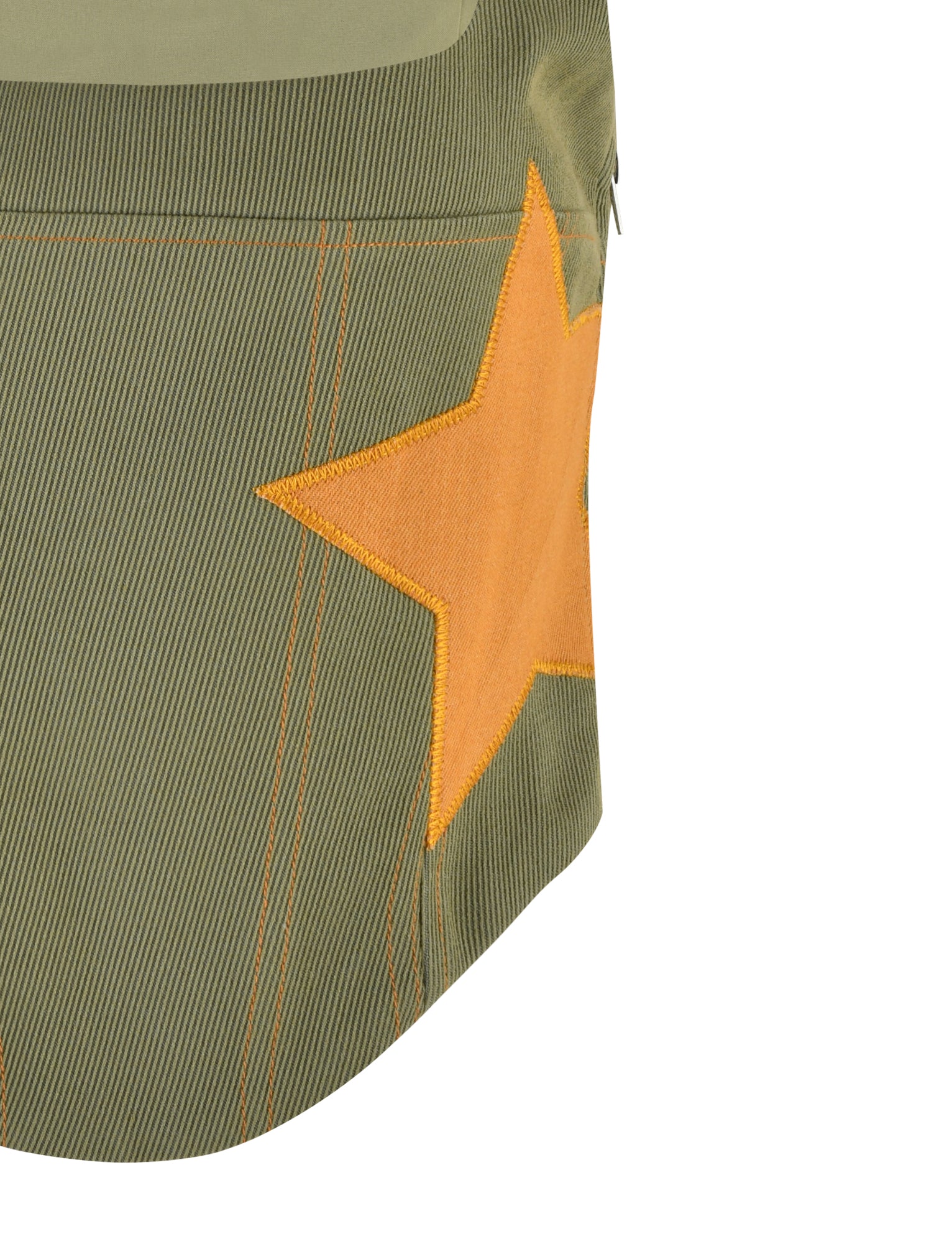 A close-up view of the TIGERMIST SULLIVAN TOP in khaki green, featuring a large, textured orange star on one side. The top has a zipper detail visible at the upper right corner. With its fine, diagonal ribbed texture, this stylish piece showcases TIGERMIST's signature flair for bold and unique designs.