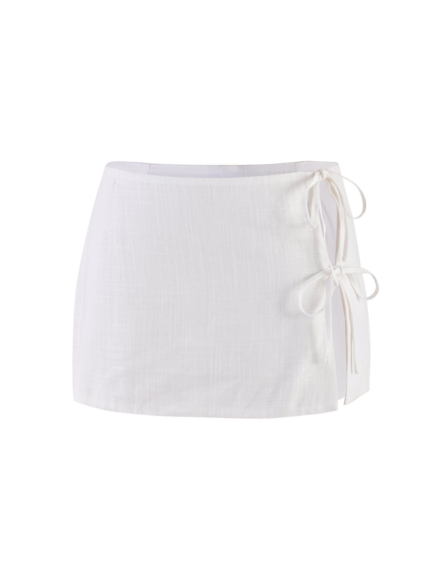 The NICOLA SKIRT - WHITE from TIGERMIST is a short, textured skirt featuring a side tie detail with two bows. It has a simple and elegant design suitable for both casual and formal wear.