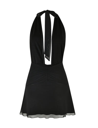 The HALIMA MINI DRESS - BLACK by TIGERMIST is a sleeveless halter dress with a ruched bodice and a flowing A-line skirt. It features a deep V-neckline and ties at the back, effortlessly blending simplicity with elegance for a truly classic and sophisticated look.